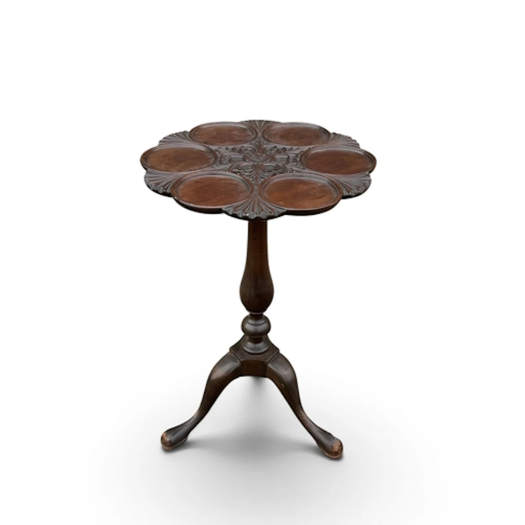 A MAHOGANY OYSTER TABLE On a turned pillar and tripod base. ...