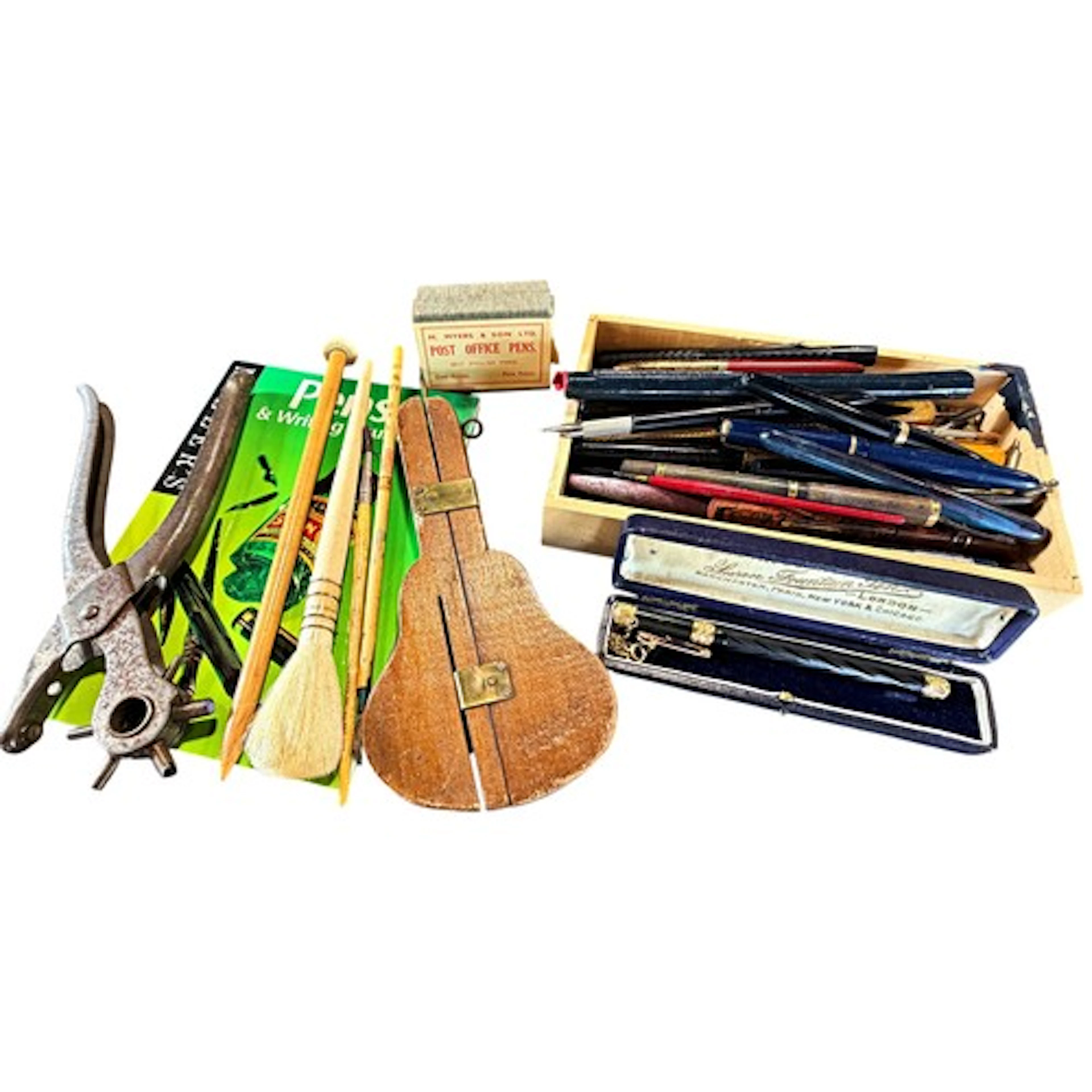 A collection of various pens and writing equipment to includ...