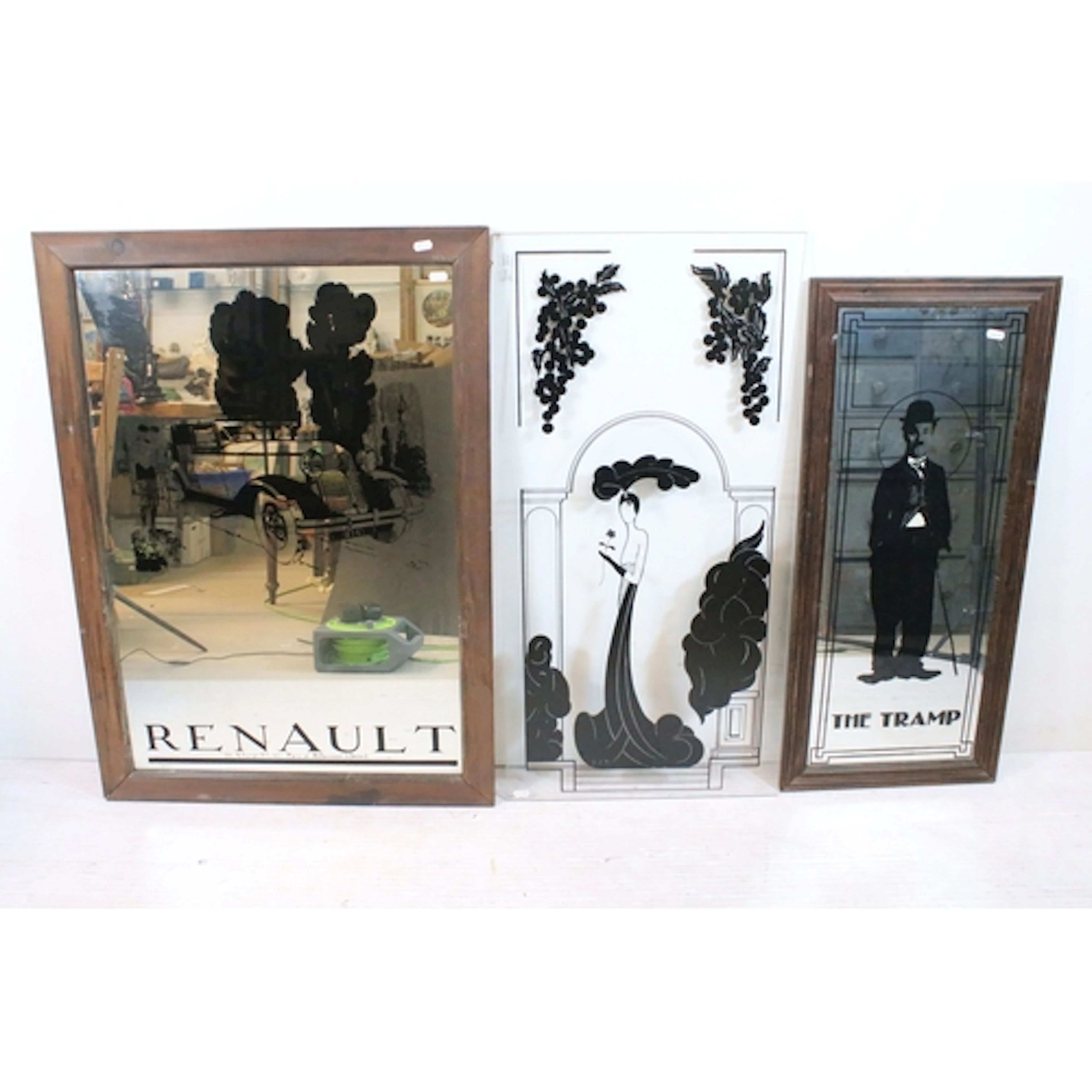 Wall mirror having central Renault car graphic, inscribed at...