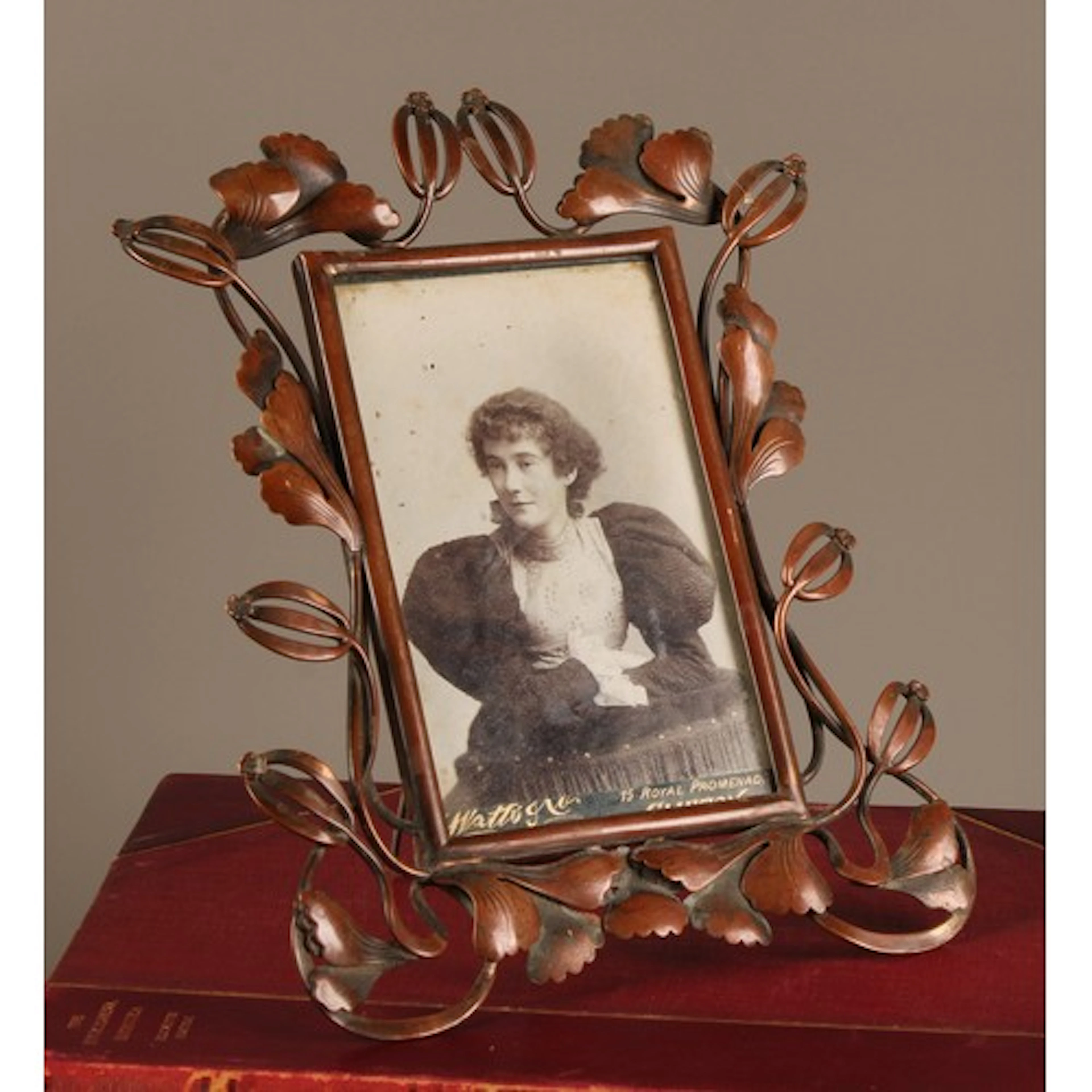 An Art Nouveau copper easel photograph frame, the bold borde...