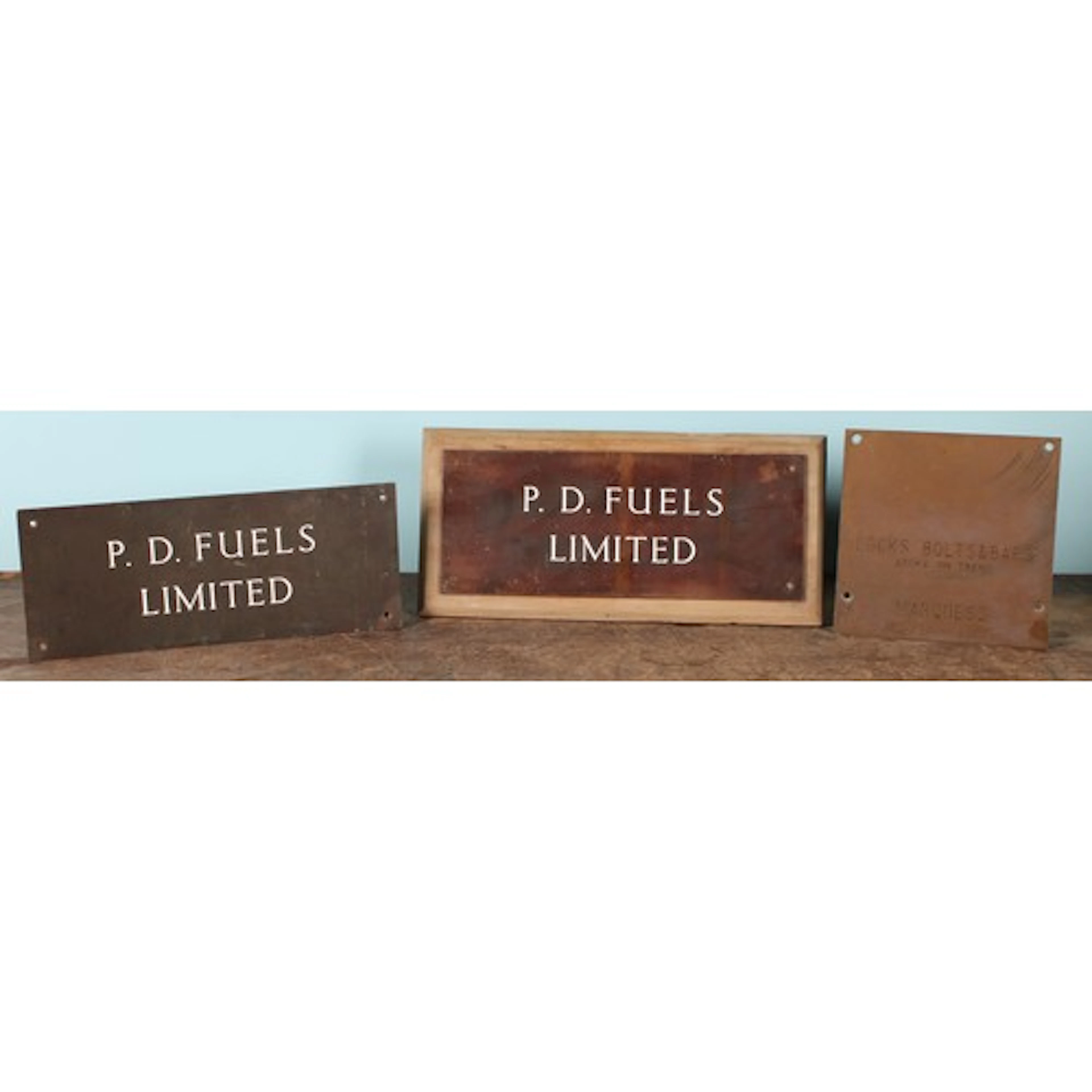 A pair of bronze rectangular plaques or signs, P.D. FUELS LI...