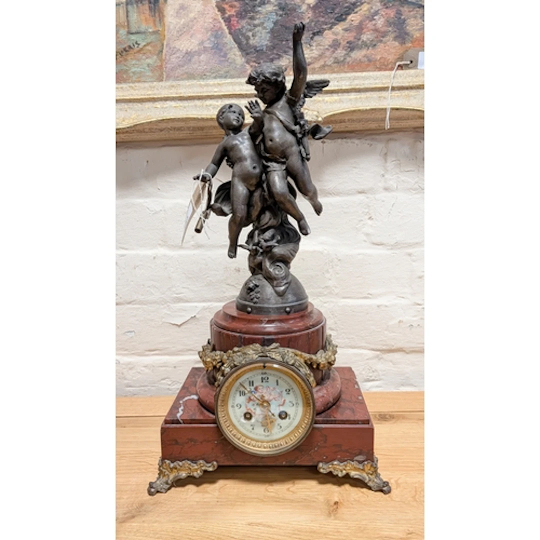 A French striking mantel clock with cherub figure mounts, st...