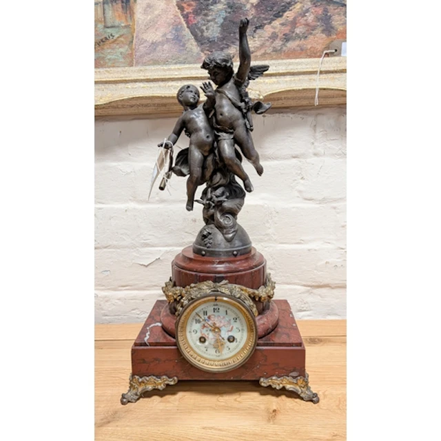 A French striking mantel clock with cherub figure mounts, st...