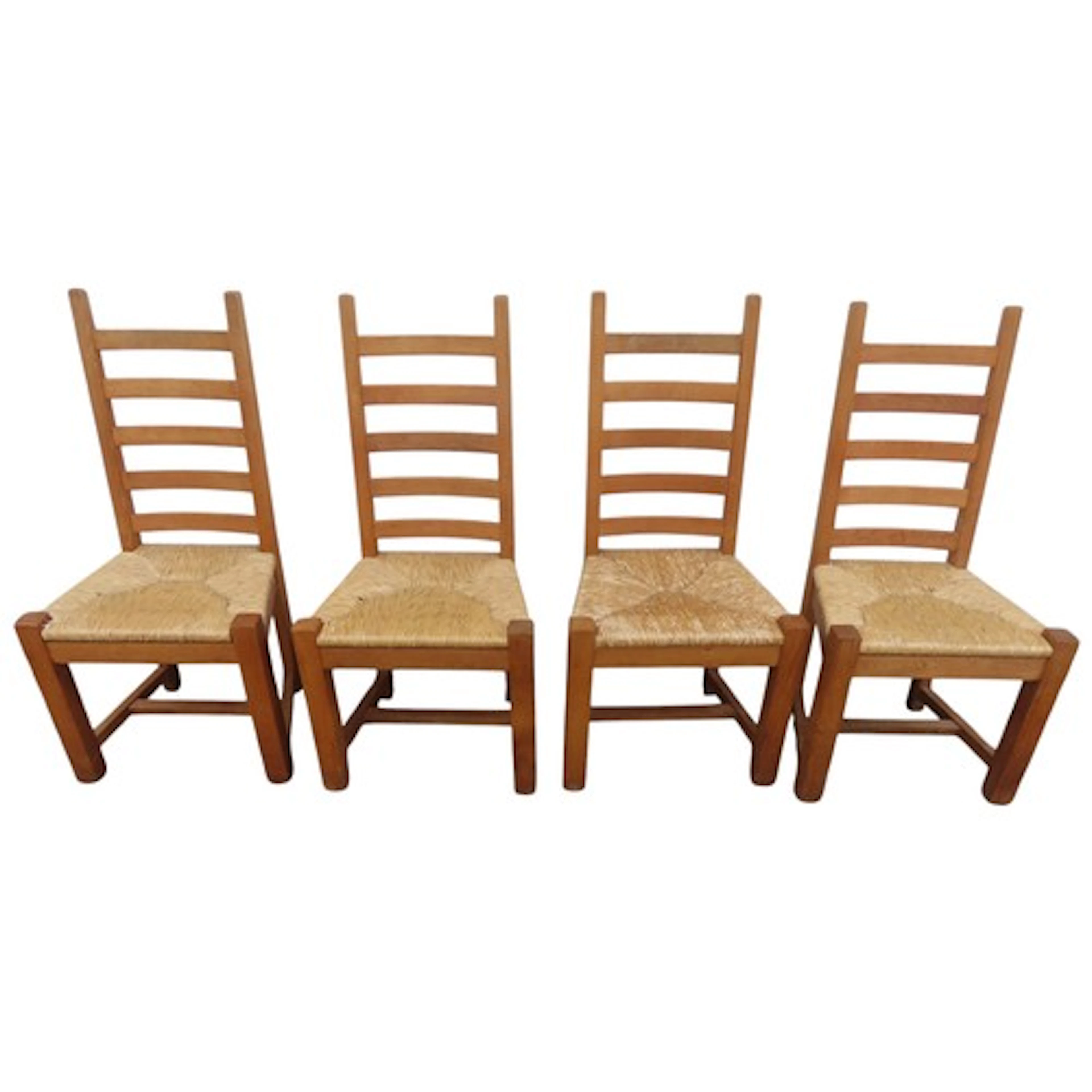 A set of four Arts & Crafts style oak ladder back dining cha...