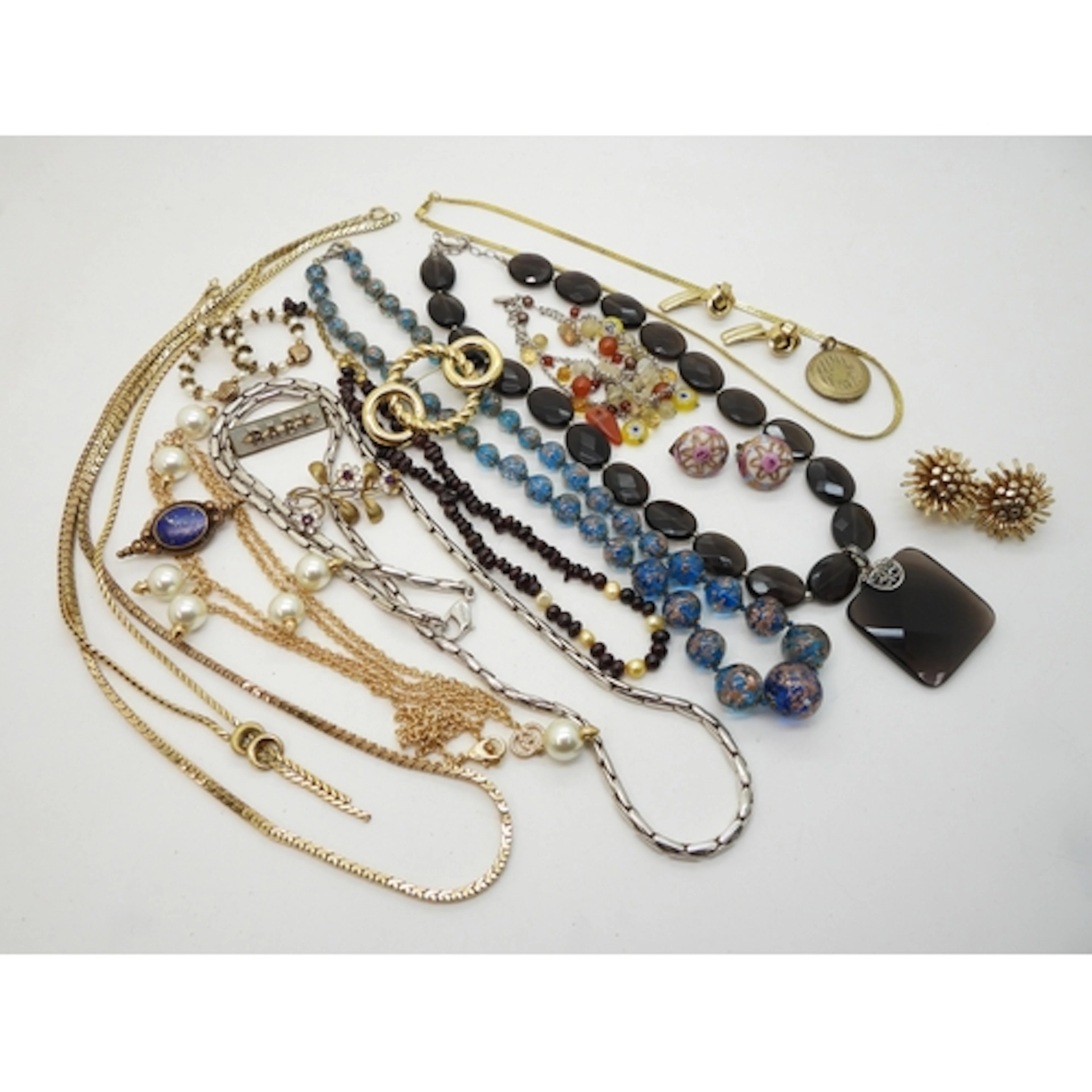 A string of garnet and pearls, a long costume white metal ch...