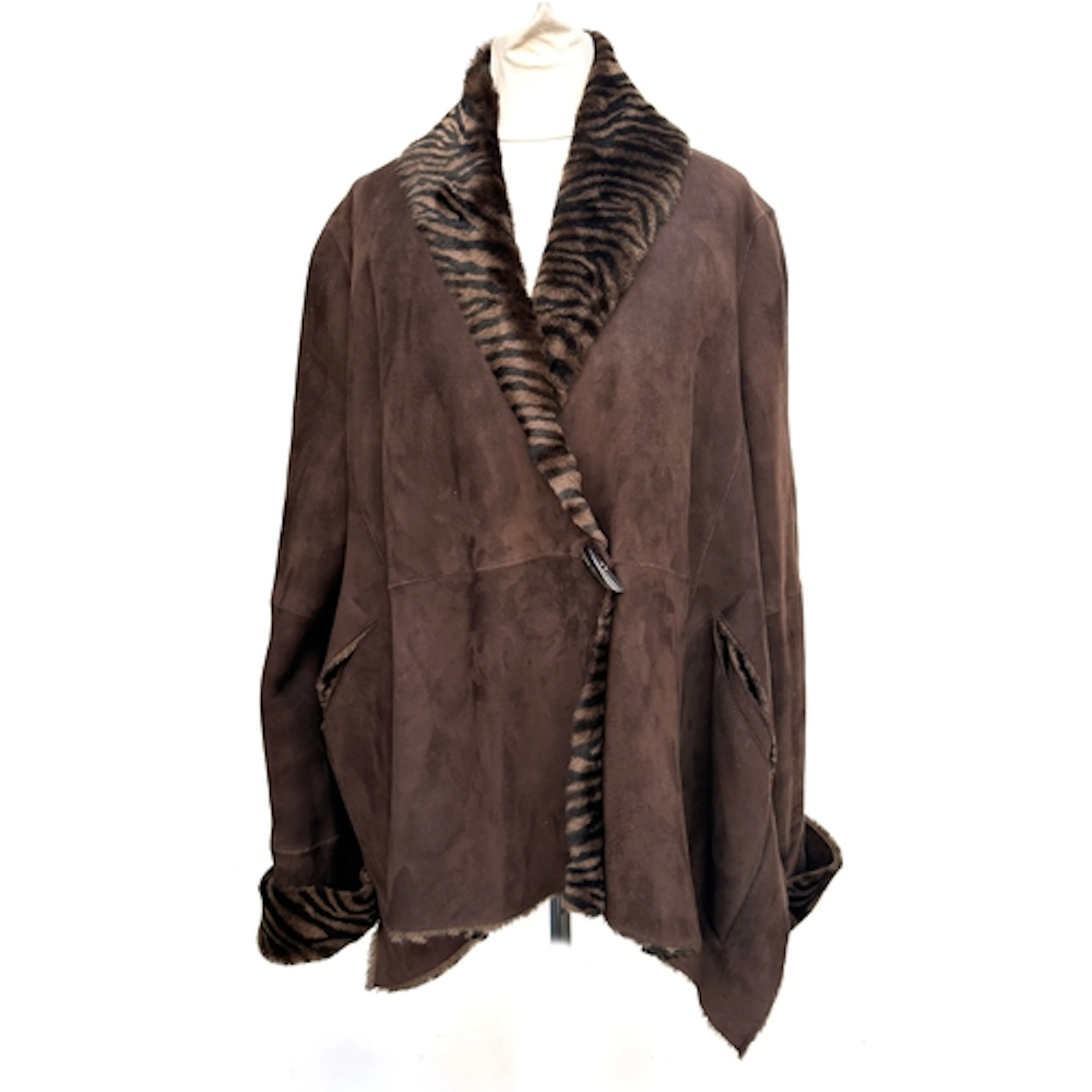 A sheepskin jacket with shawl collar and faux striped fur li...