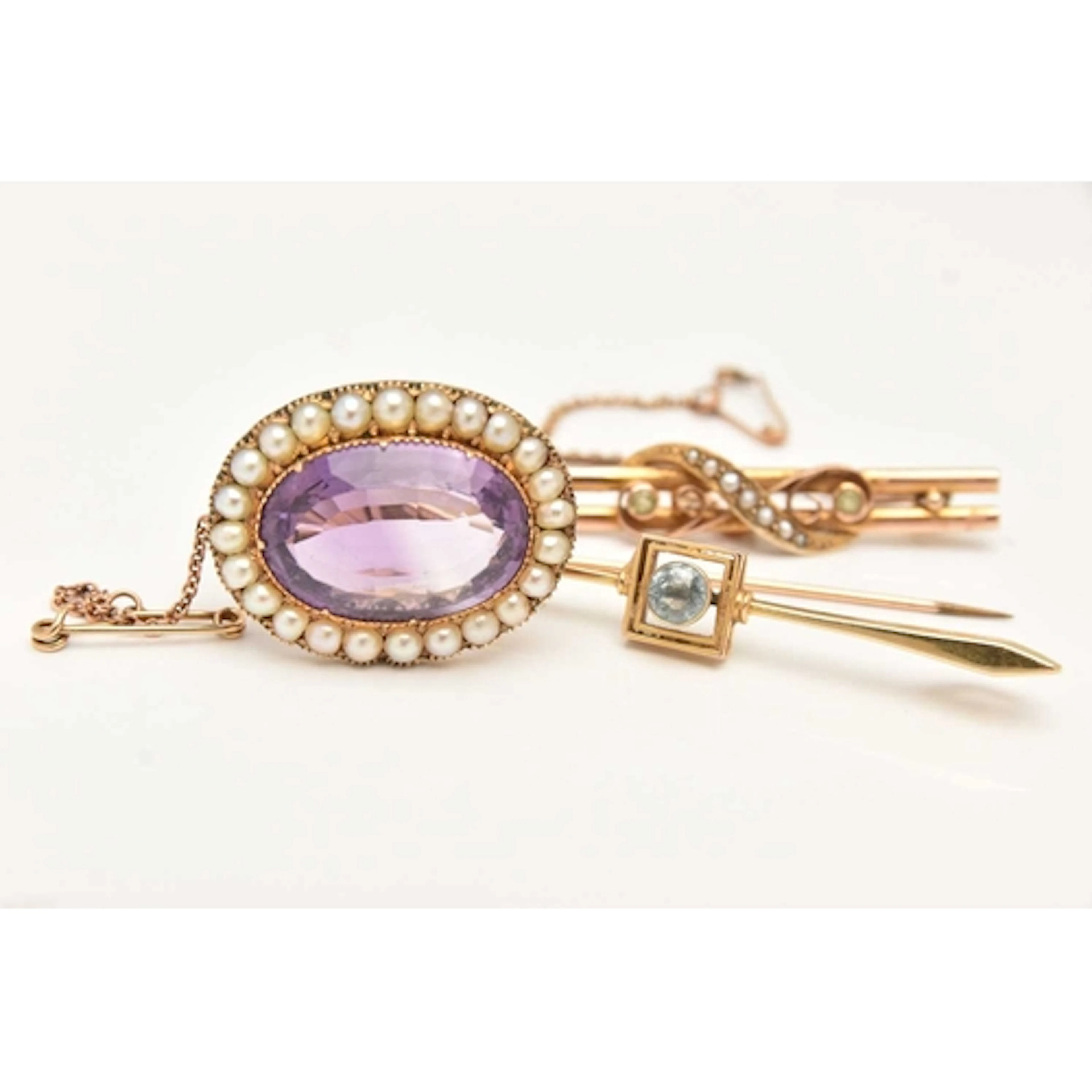 THREE BROOCHES, to include a 15ct gold bar brooch set with a...
