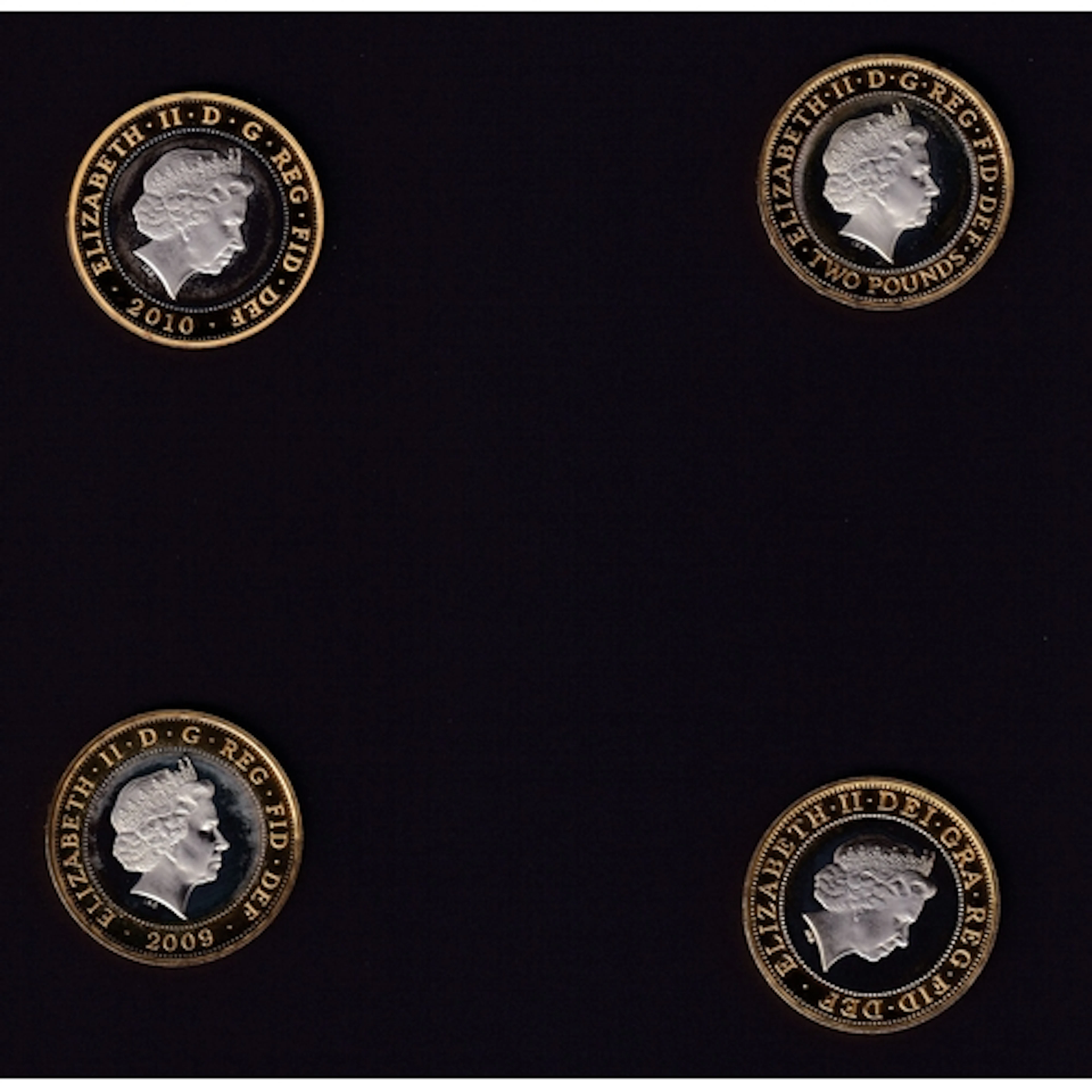 A group of four UK Queen Elizabeth II silver proof £2 coins,...