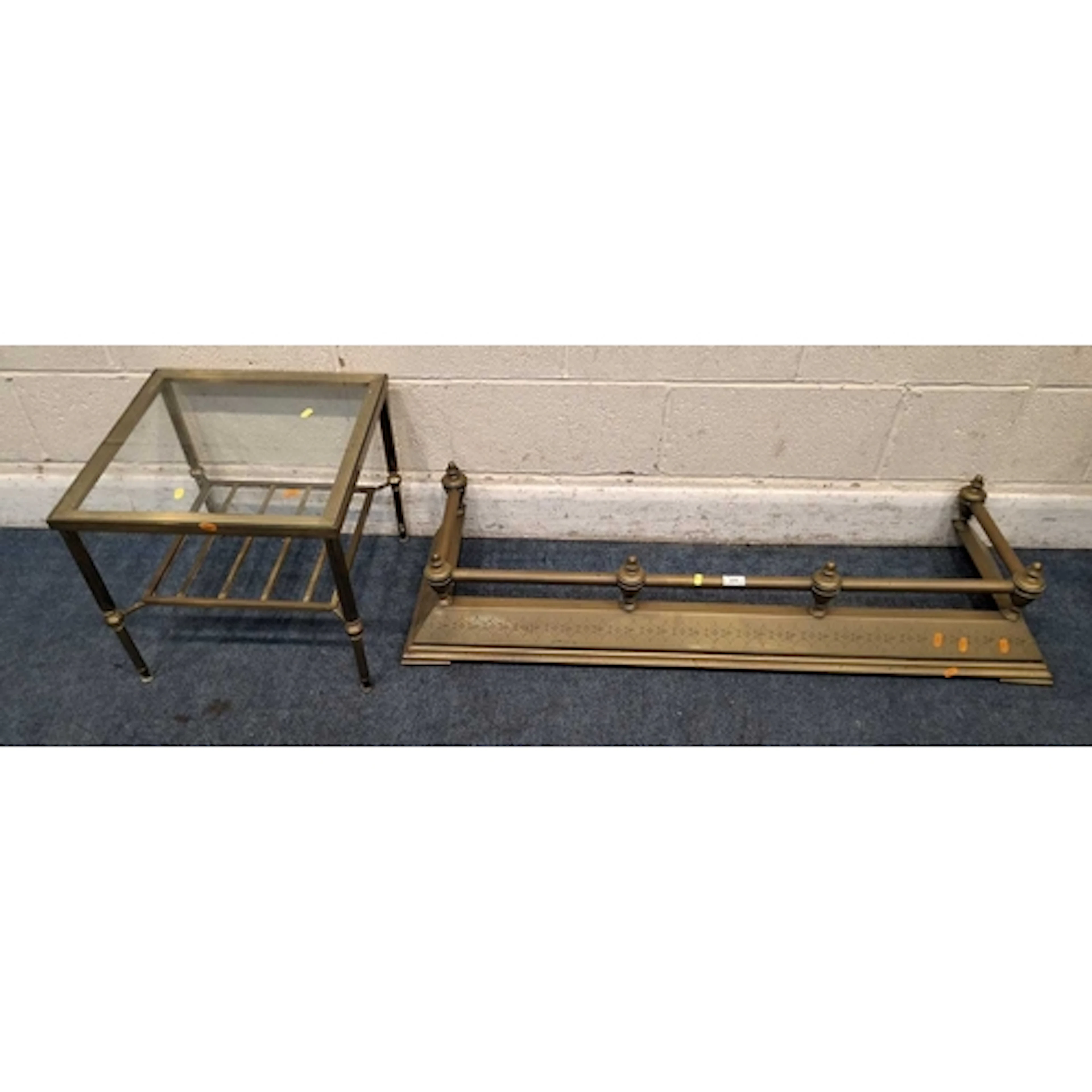 A BRASS FENDER, along with an occasional table with a glass ...