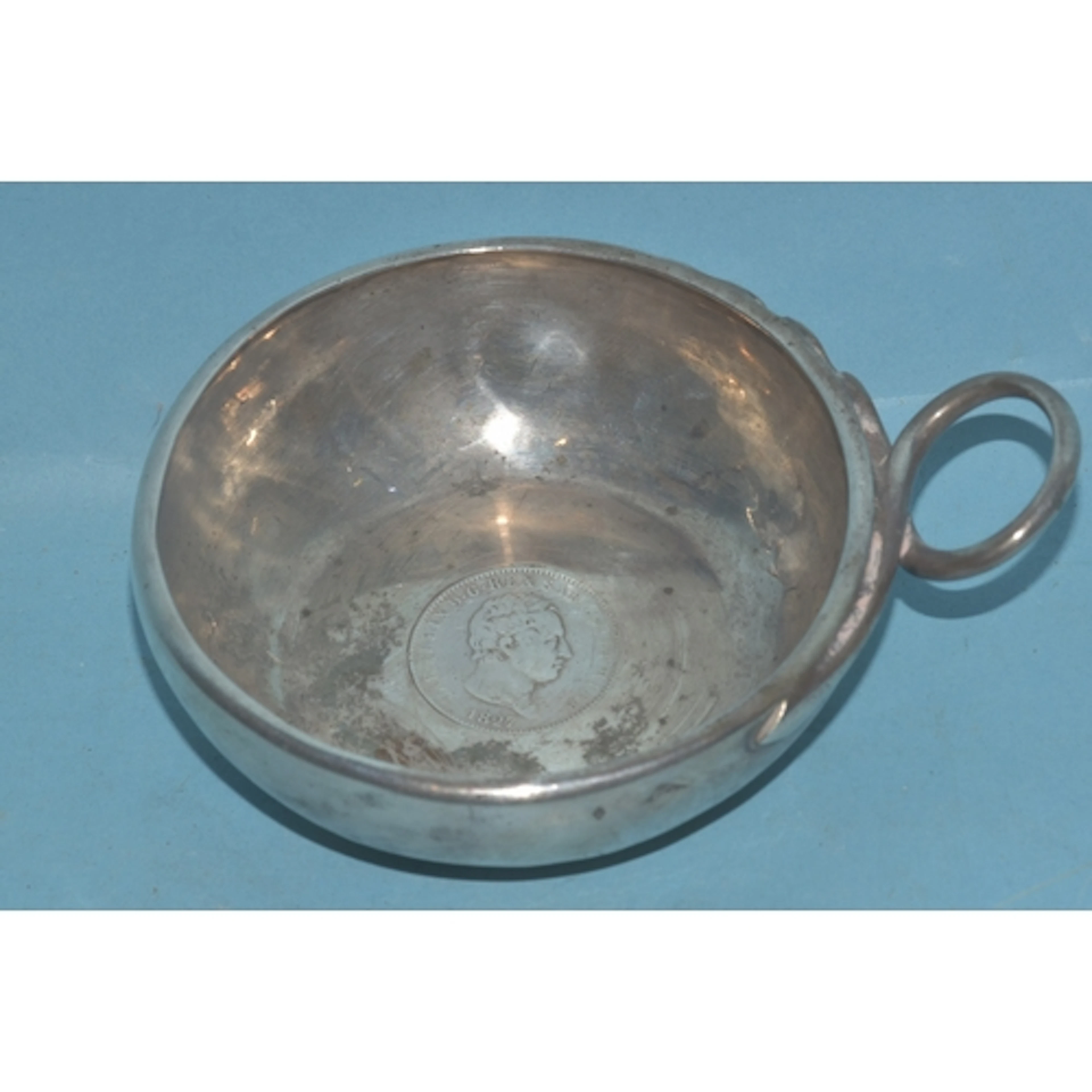 A Continental white metal wine taster of circular form, with...