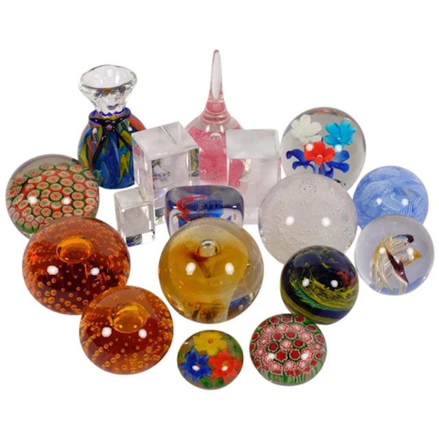 A group of 17 glass paperweights, including floral and fish ...
