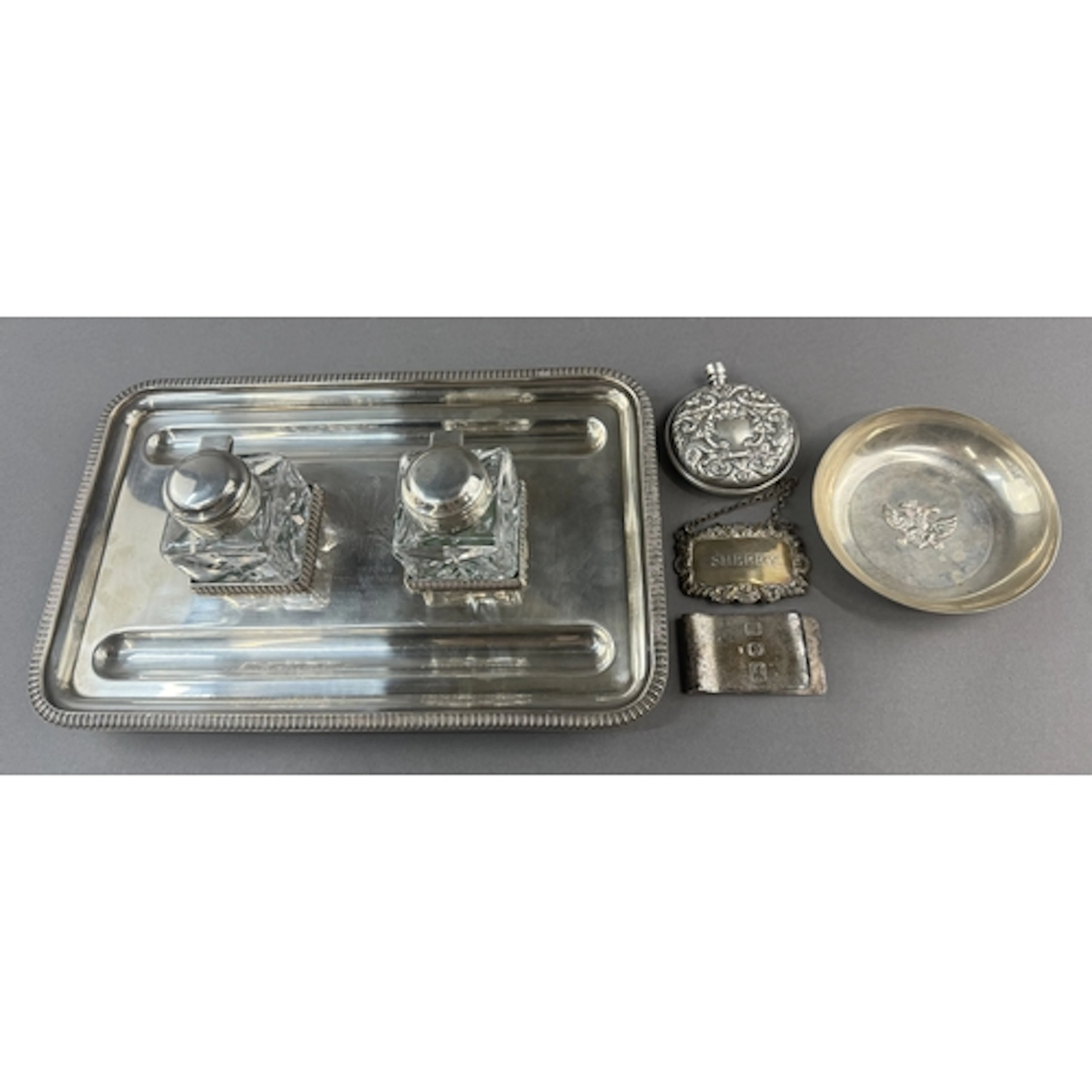 Silver & Plate: a plated double inkwell standish, engrav...