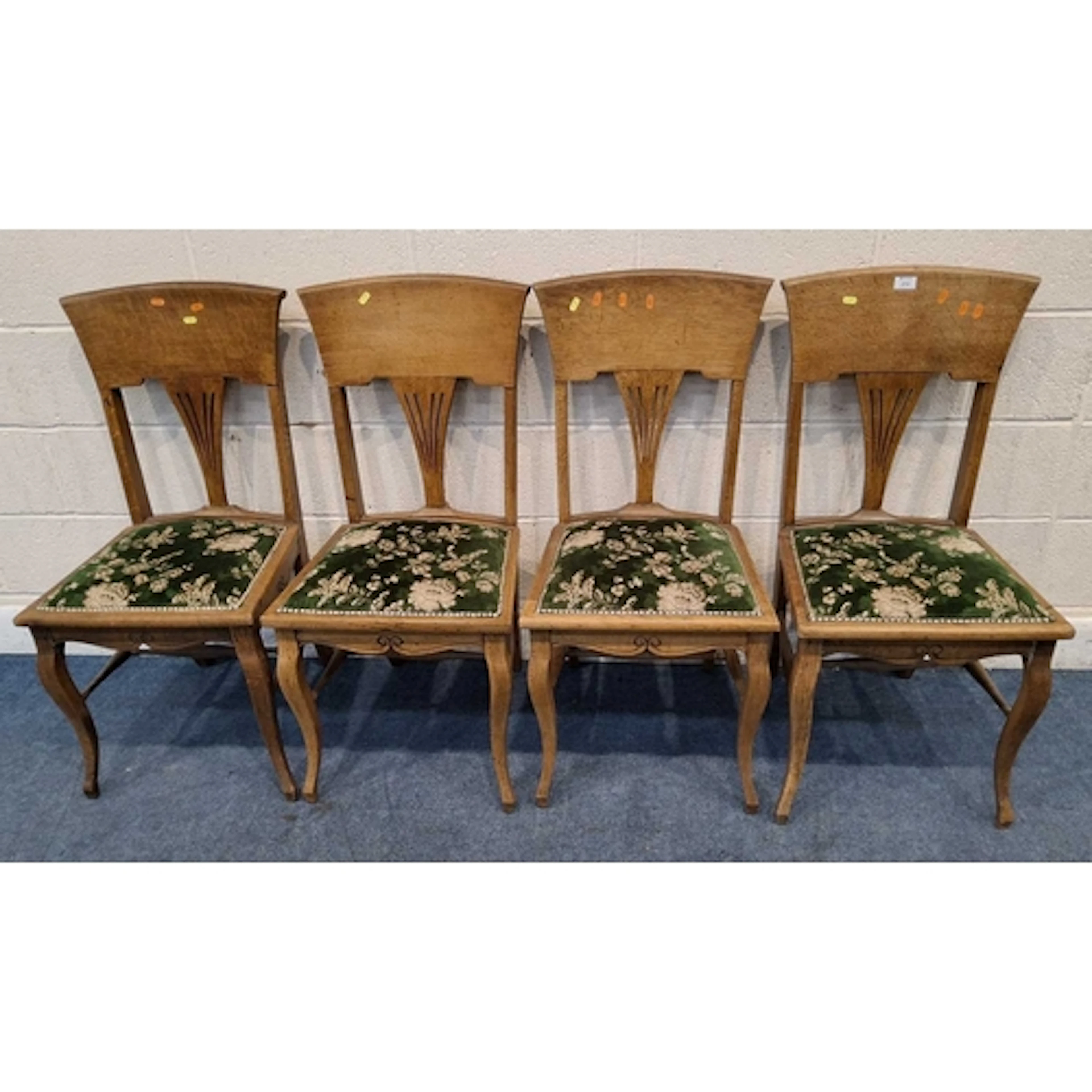 A SET OF FOUR ARTS AND CRAFTS OAK CHAIRS, with green and fol...