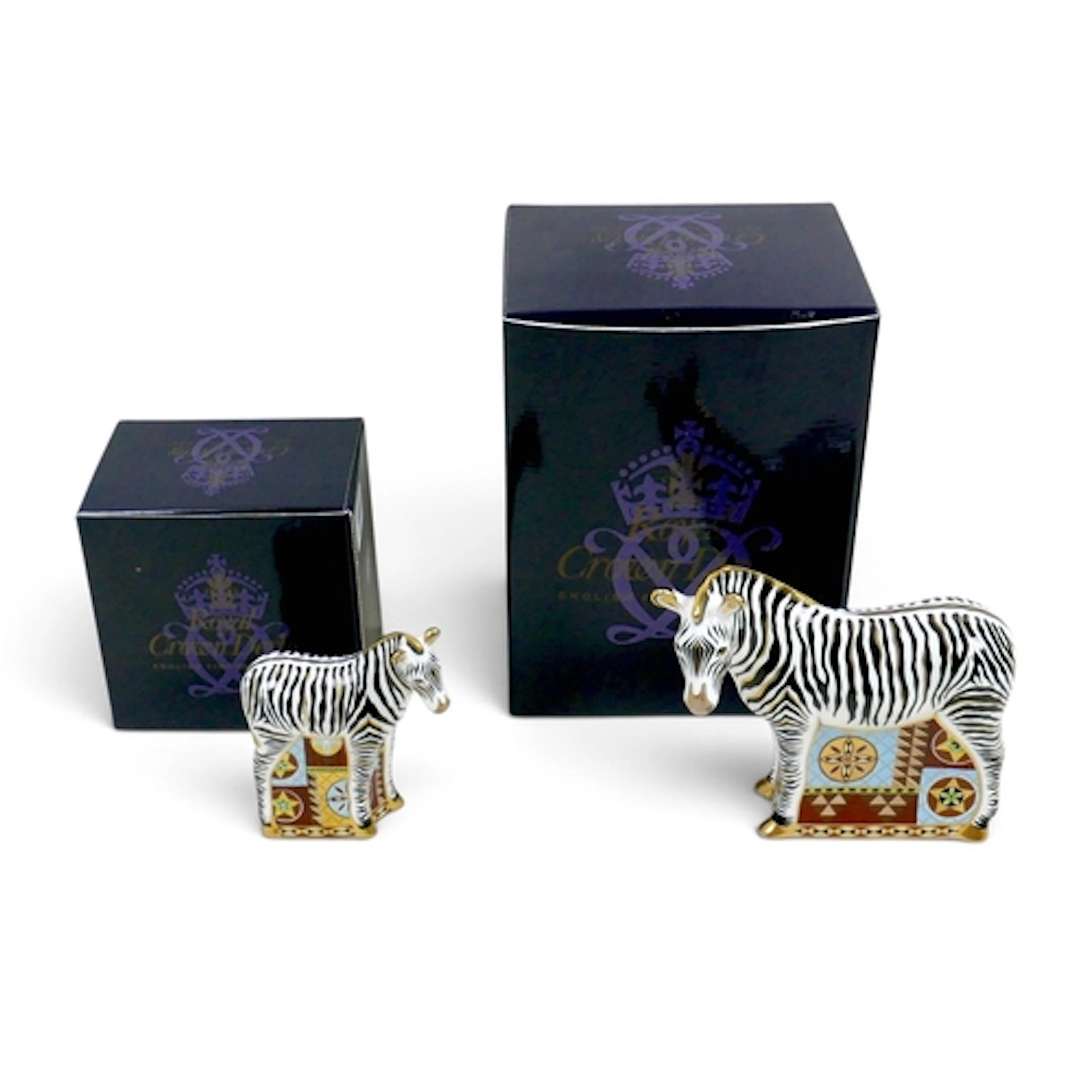 TWO ROYAL CROWN DERBY ZEBRA PAPERWEIGHTS. Comprising an adul...