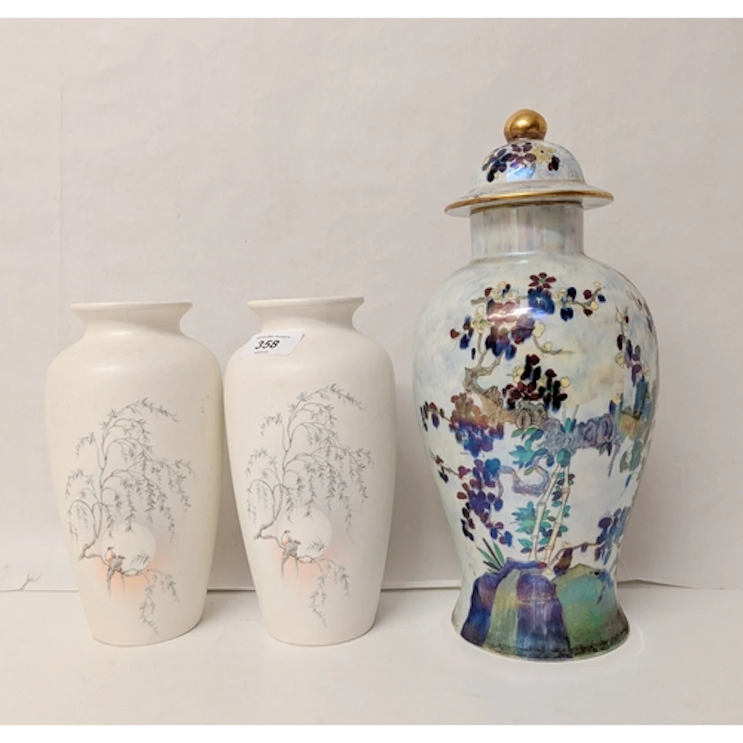 A pair of Poole Pottery vases, decorated with birds in a Jap...