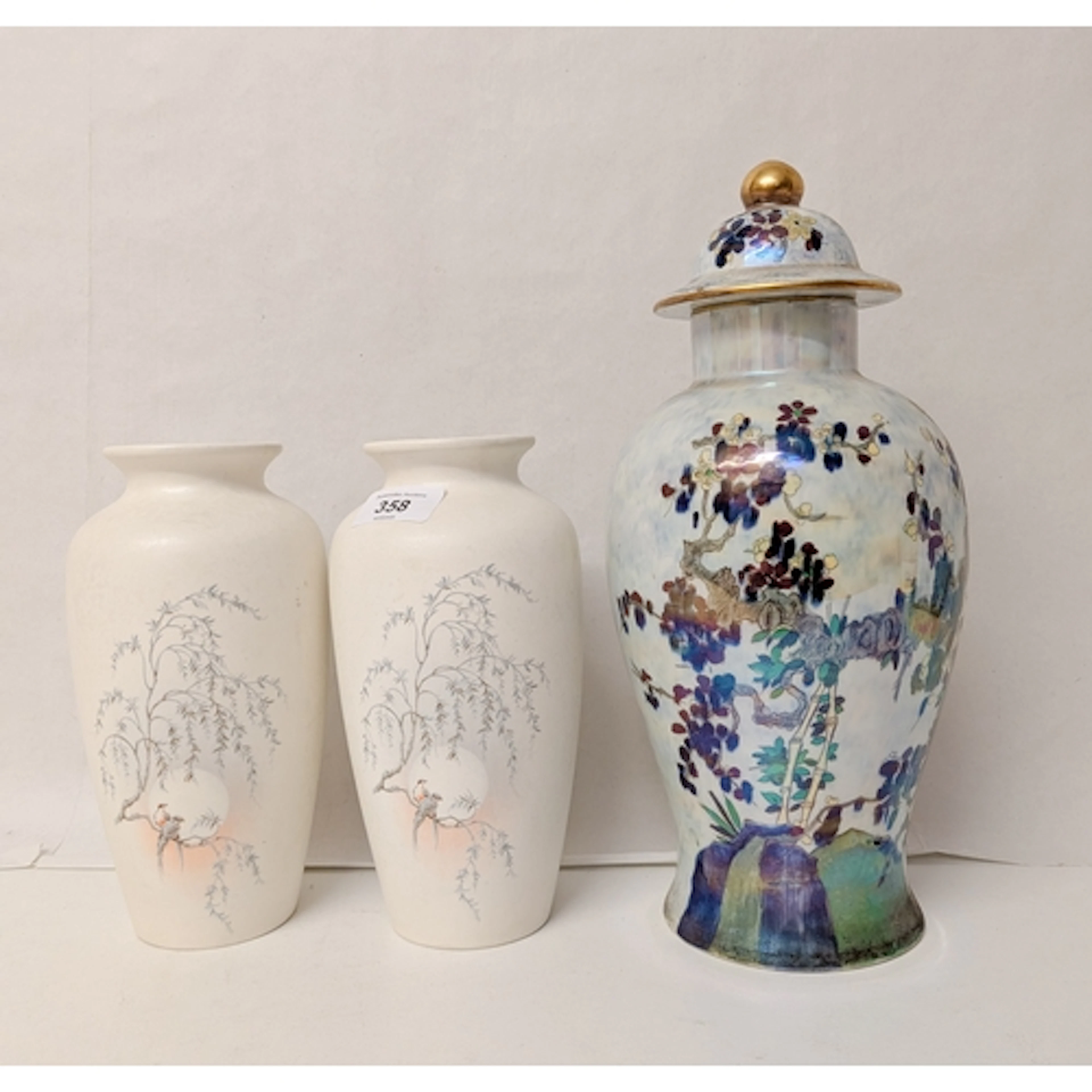 A pair of Poole Pottery vases, decorated with birds in a Jap...