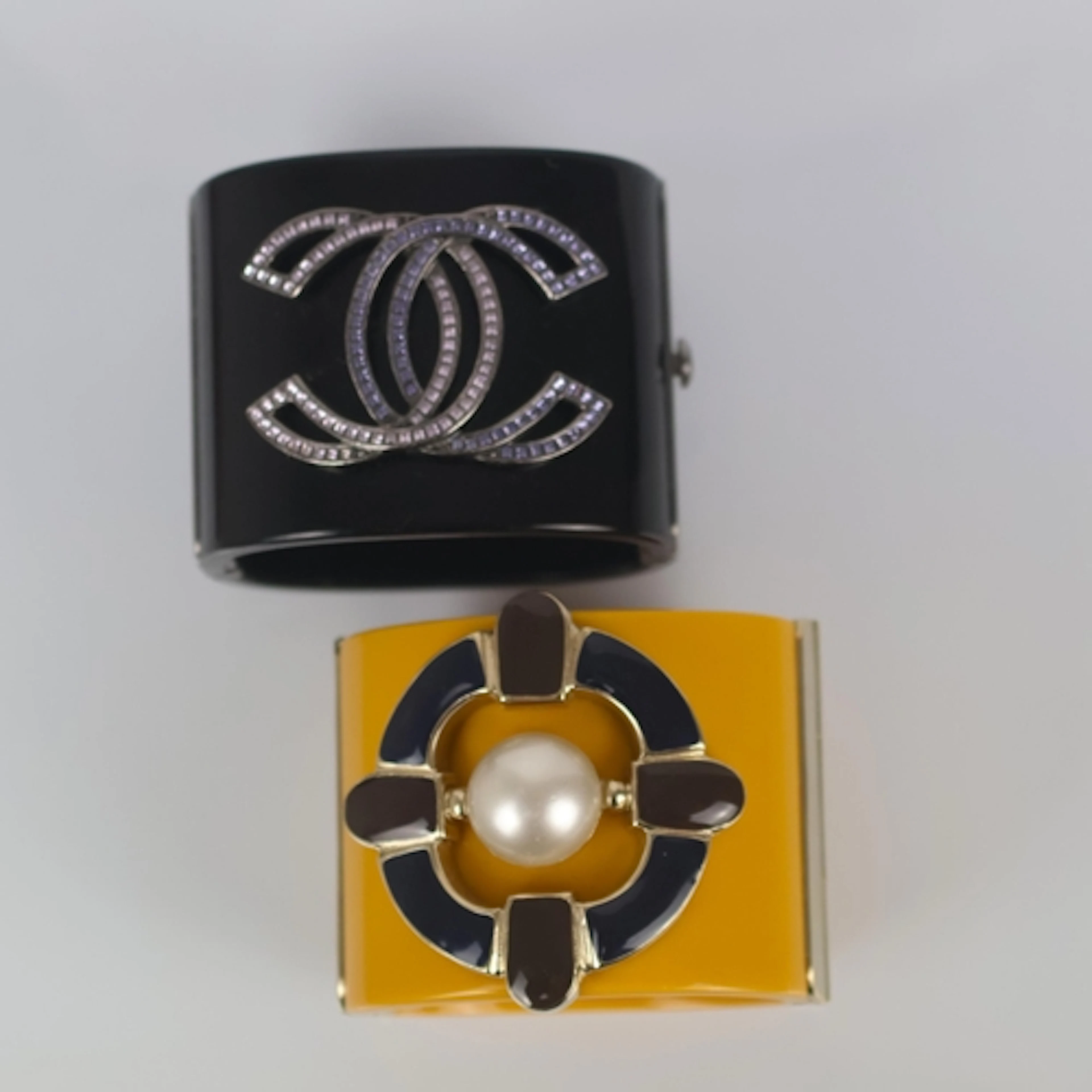 A contemporary Chanel cuff, the black cuff with applied past...