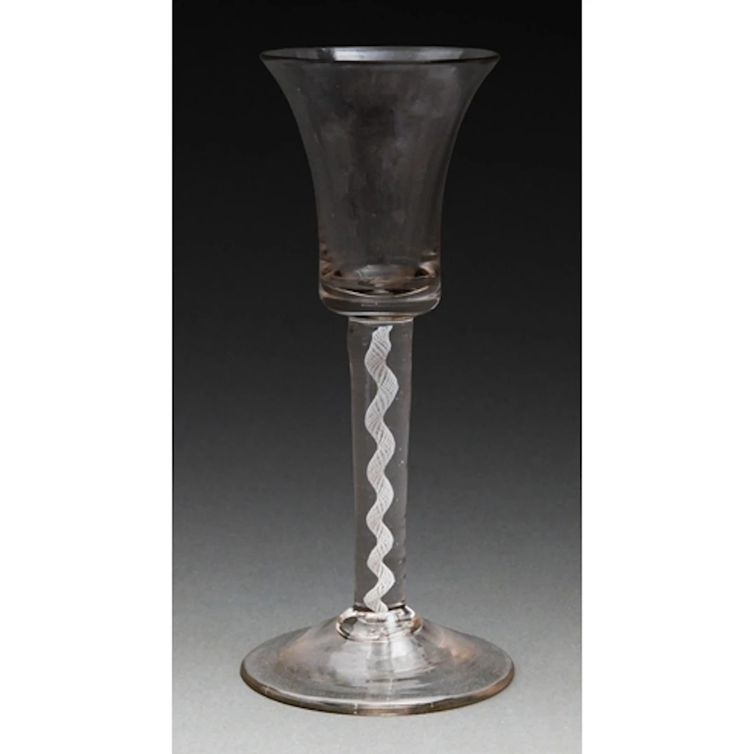 A George III wine glass, c1765, the waisted bell bowl on a m...