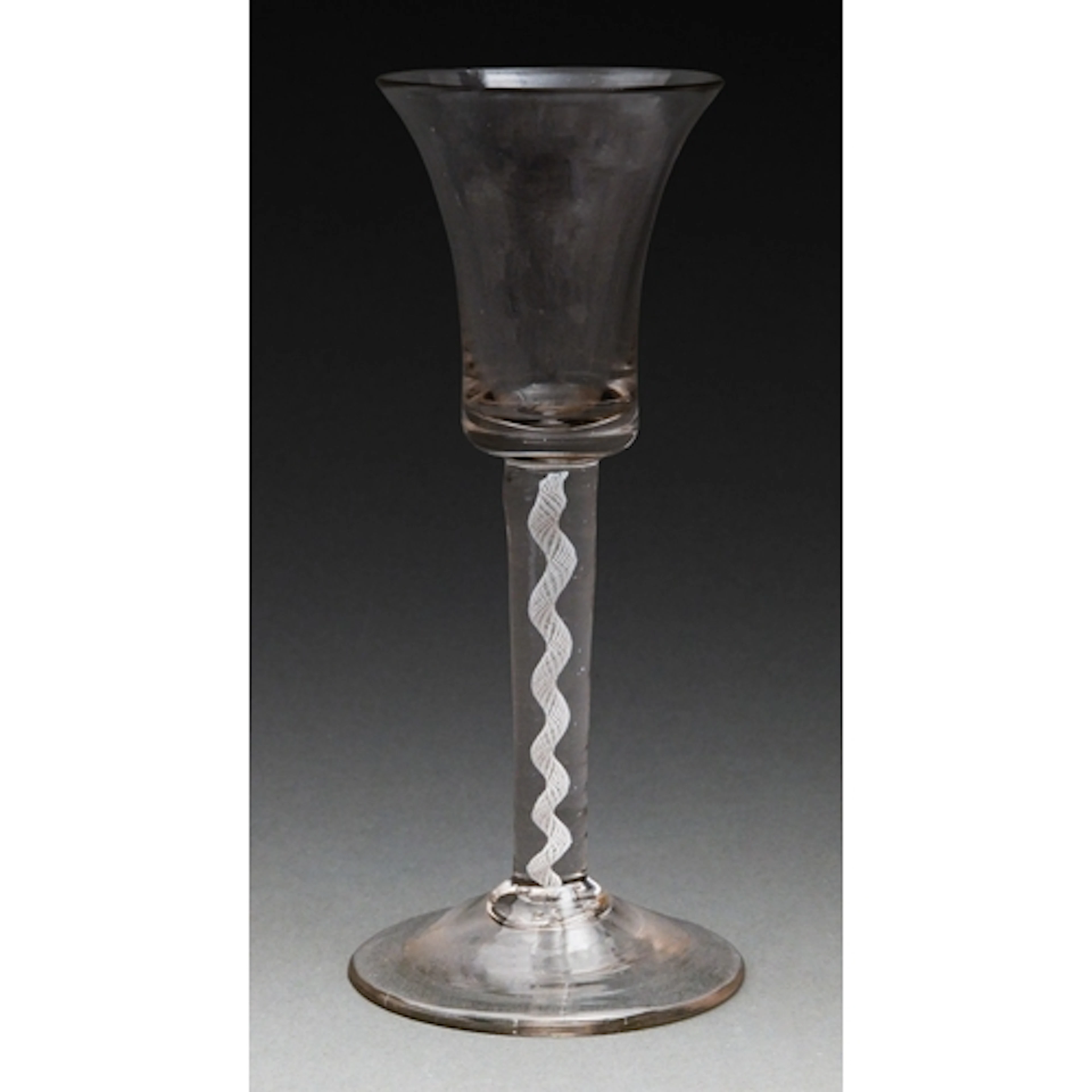A George III wine glass, c1765, the waisted bell bowl on a m...