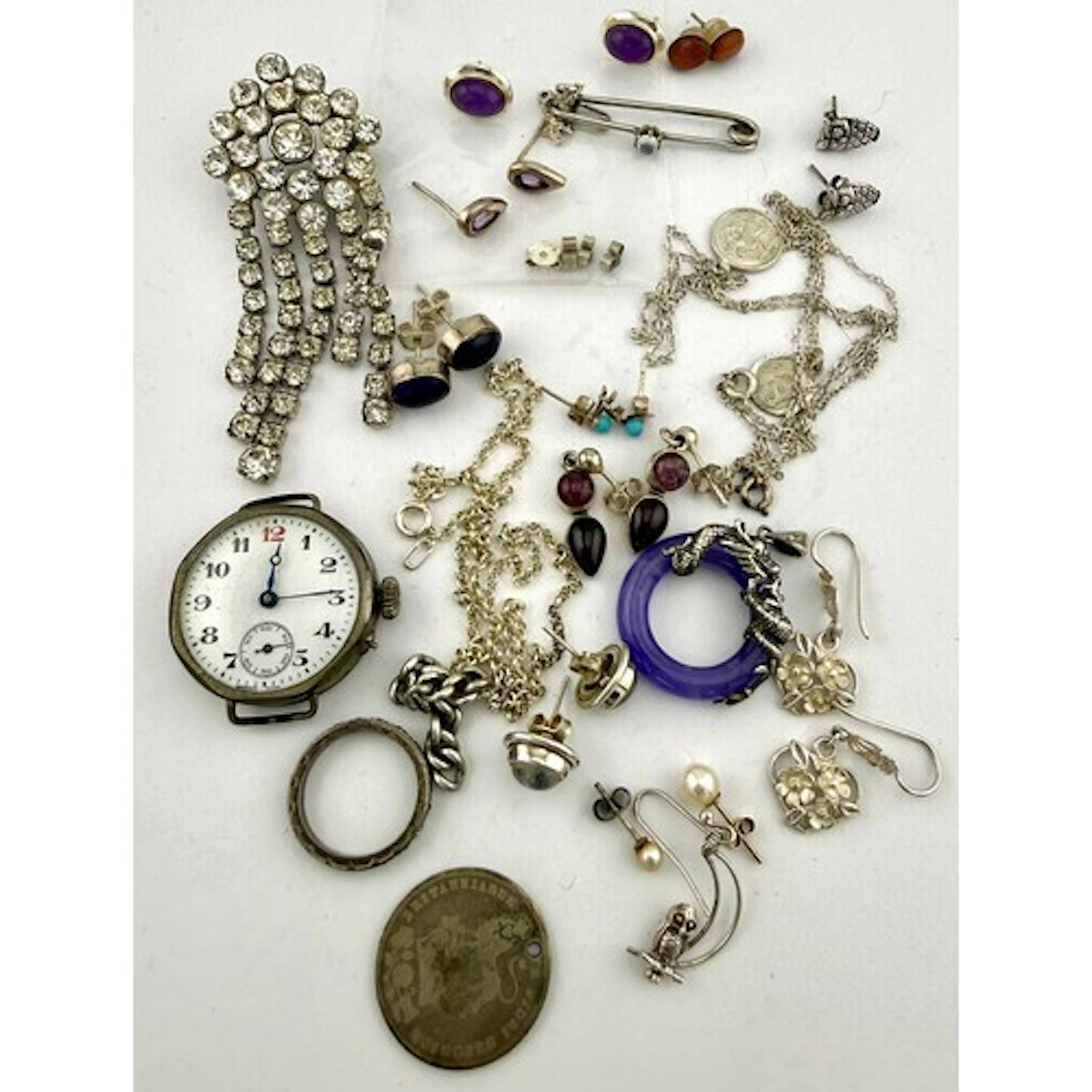 A collection of white metal, costume, silver items to includ...