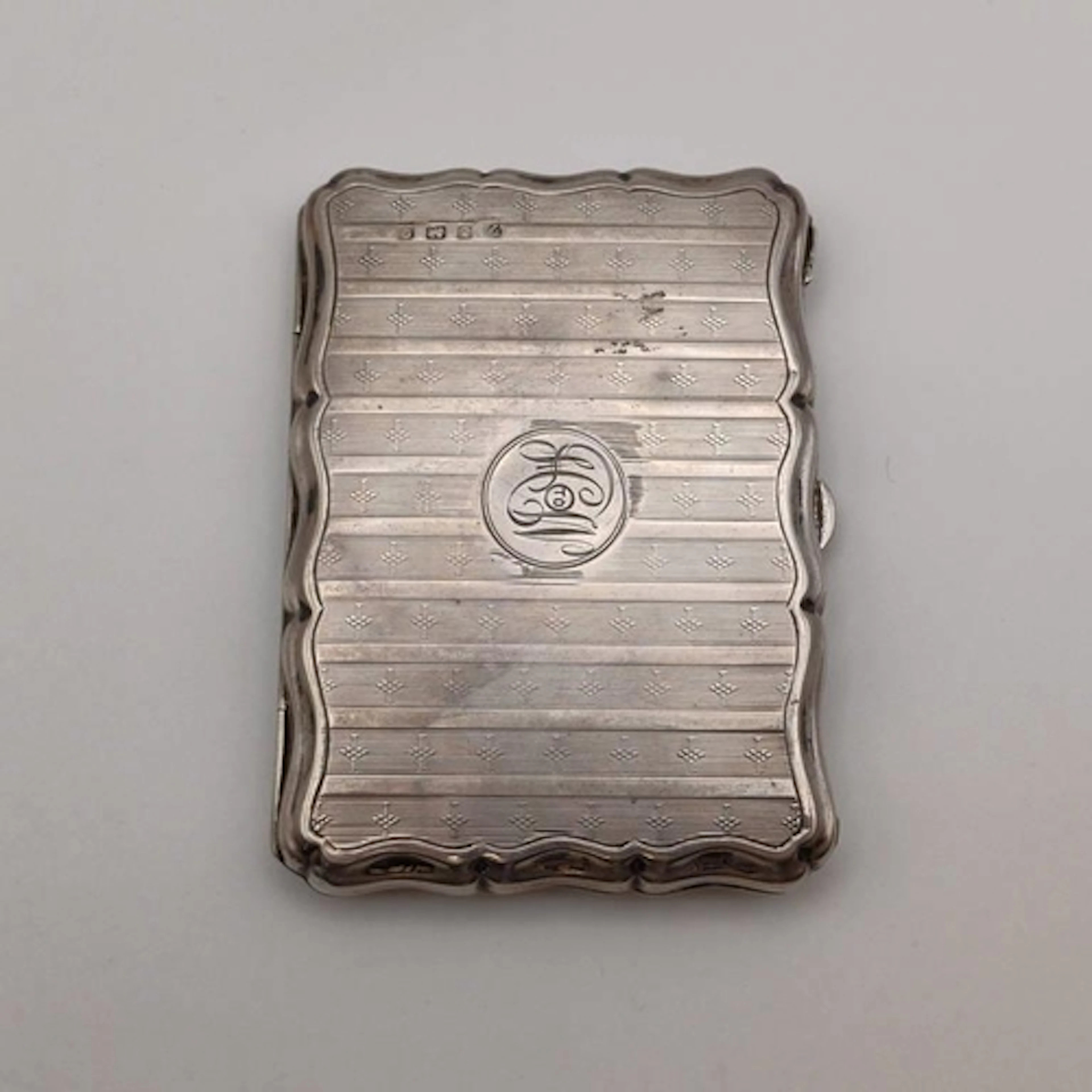 A SILVER CARD CASE WITH LEATHER INTERIOR & PENCIL BY A & J Z...