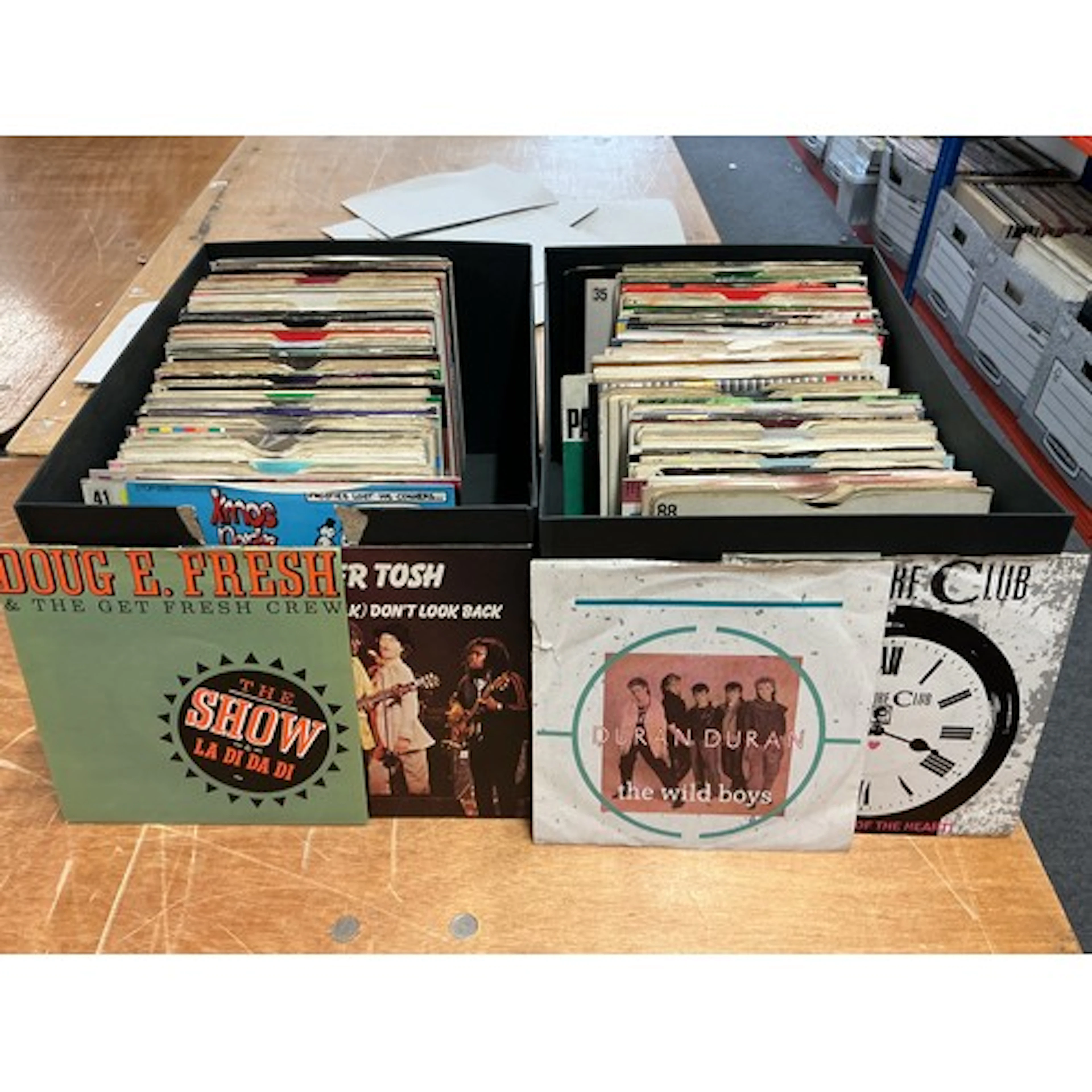 Ten boxes of 7” singles by various artists including Madonna...
