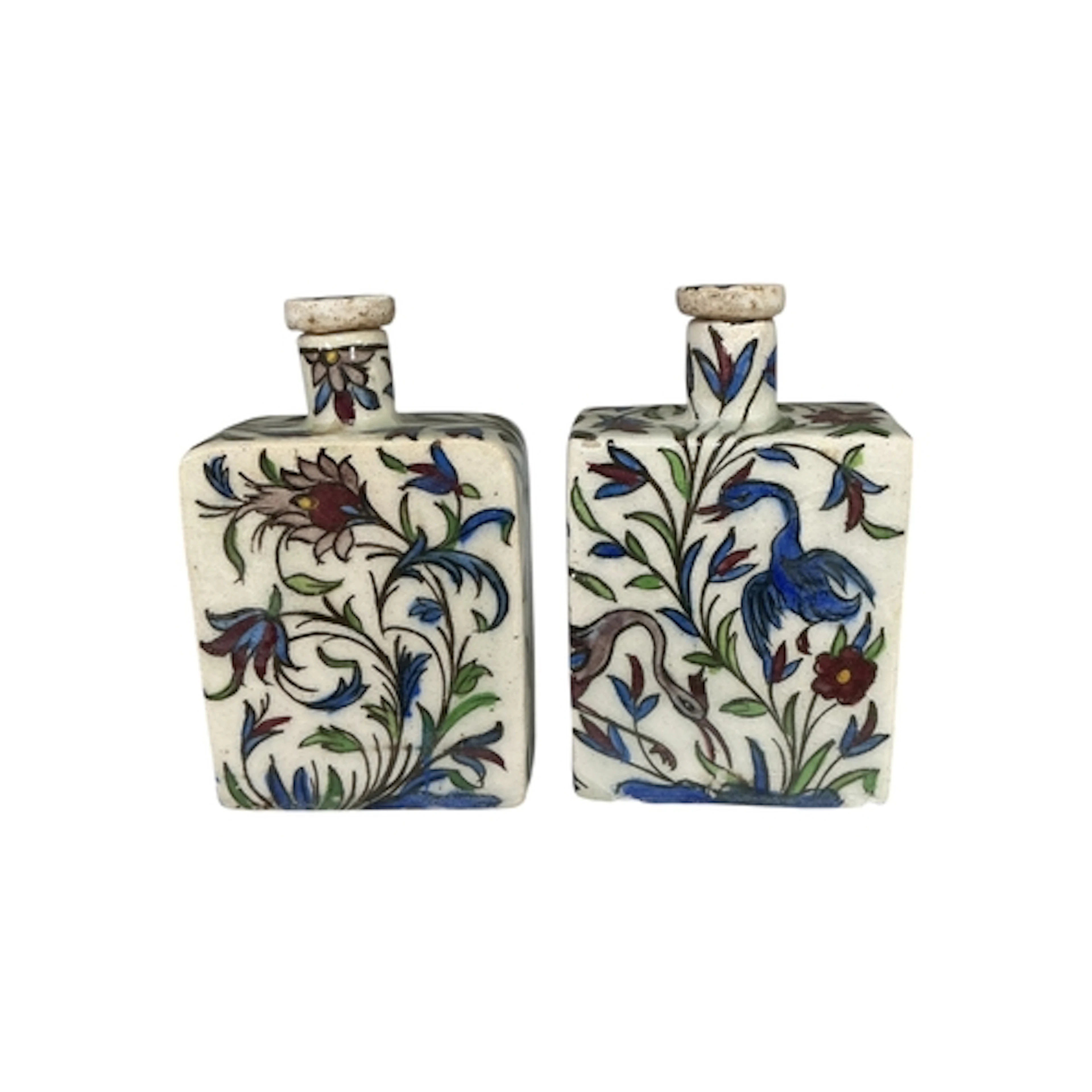 A pair of Iznik pottery flasks and stoppers, decorated with ...