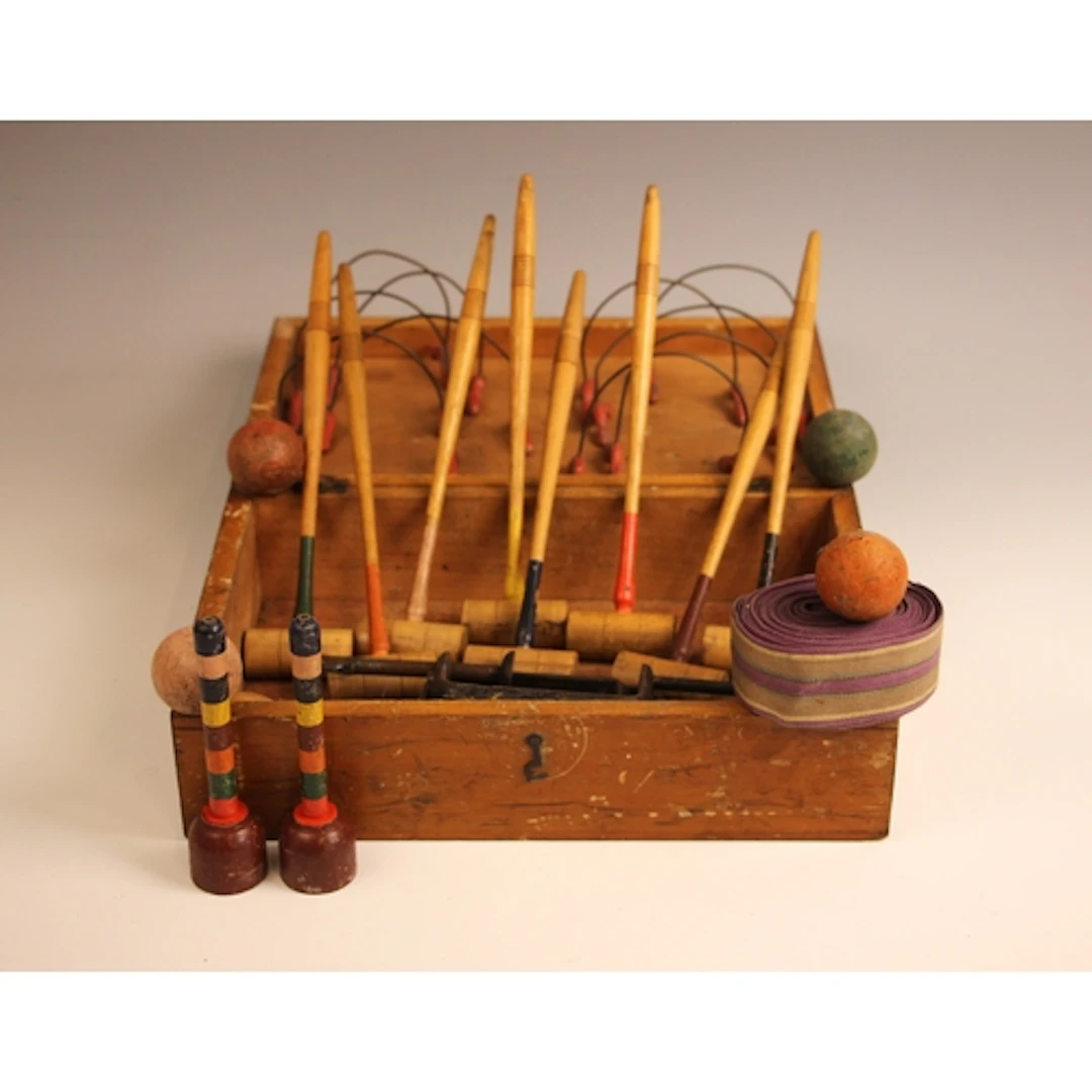 A vintage table-top croquet set, comprising: eight mallets, ...
