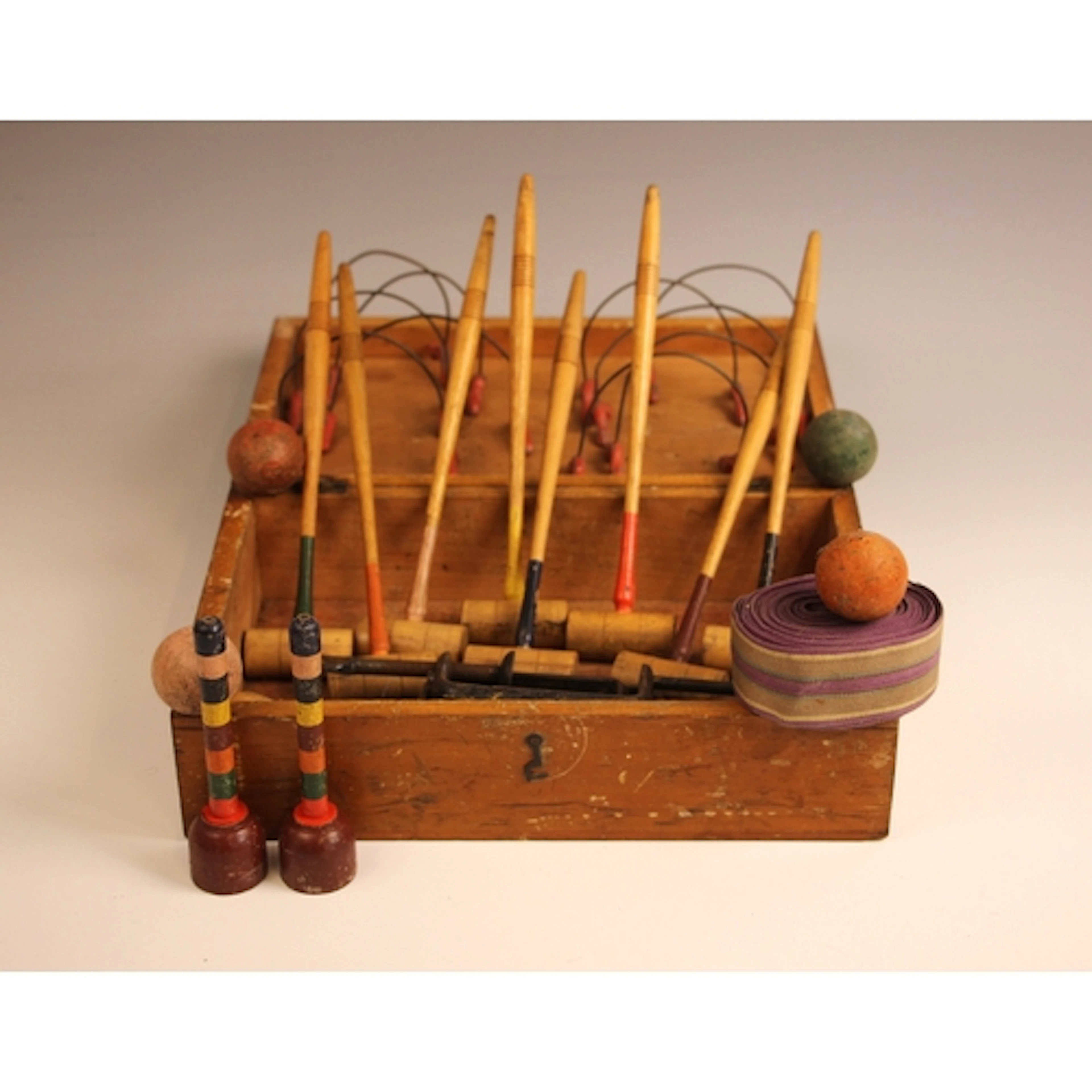 A vintage table-top croquet set, comprising: eight mallets, ...