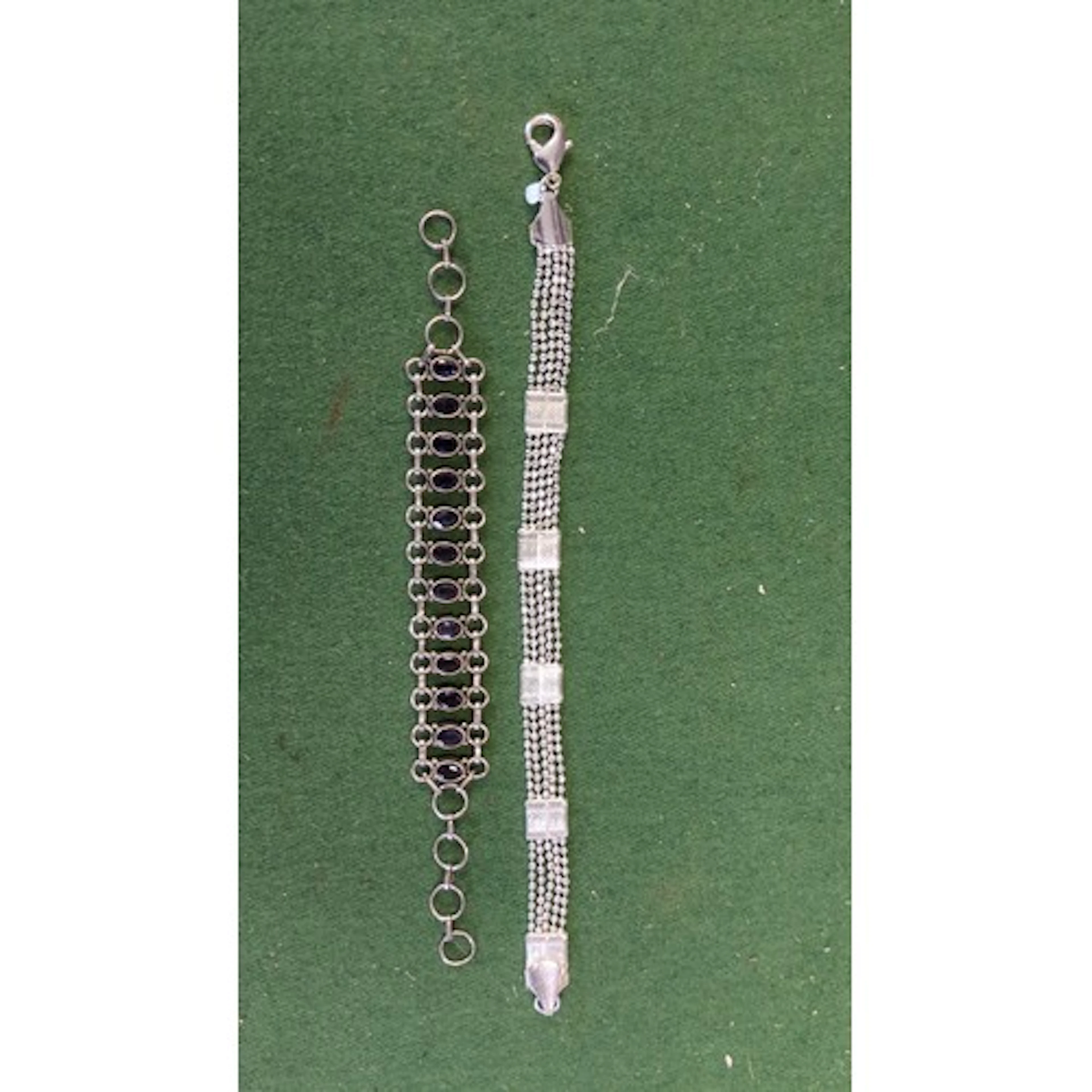 Two silver bracelets: one set with a line of oval faceted vi...