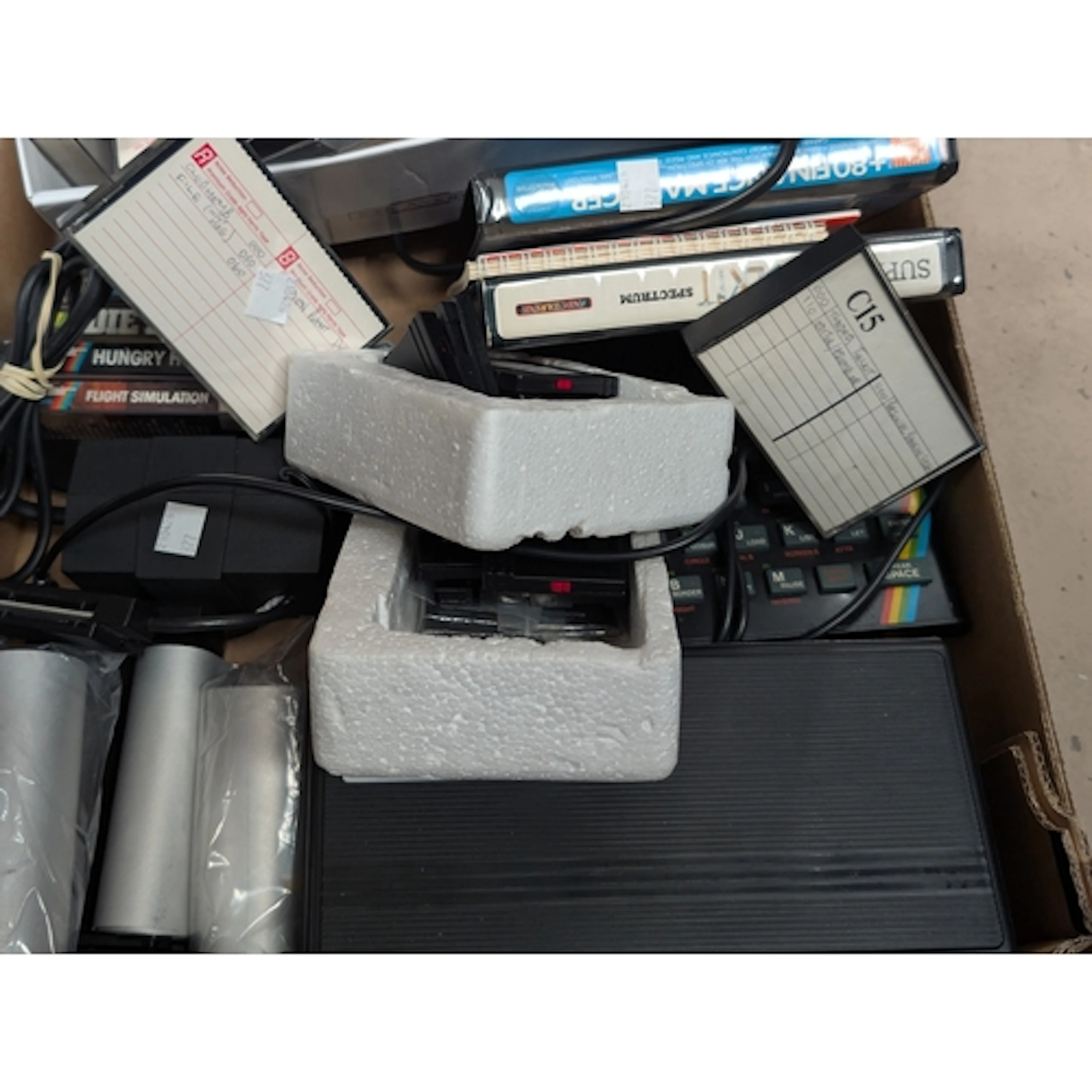 A vintage Sinclair ZX Spectrum computer with printer and a s...