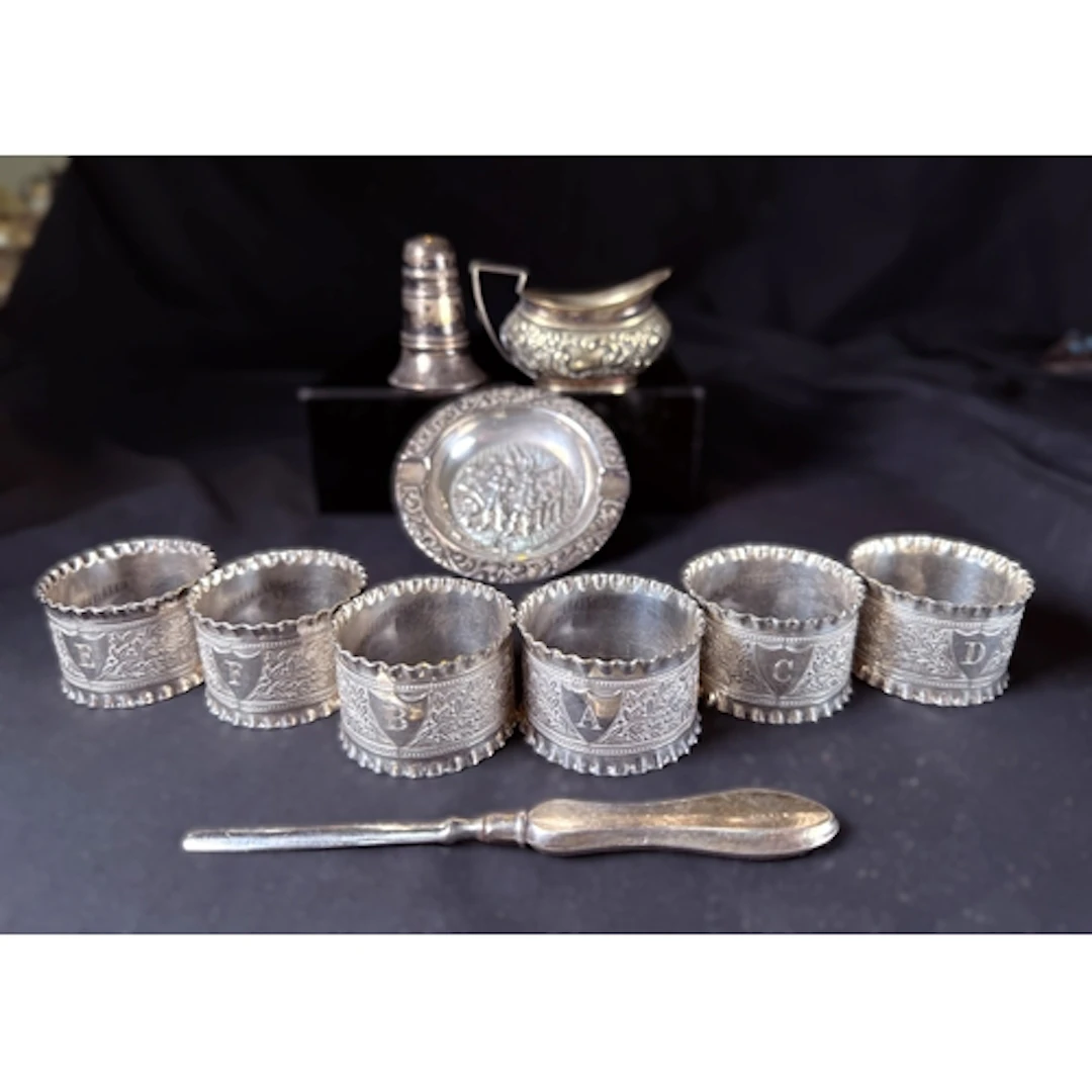 A hallmarked silver pepper pot (weighted base); a white meta...