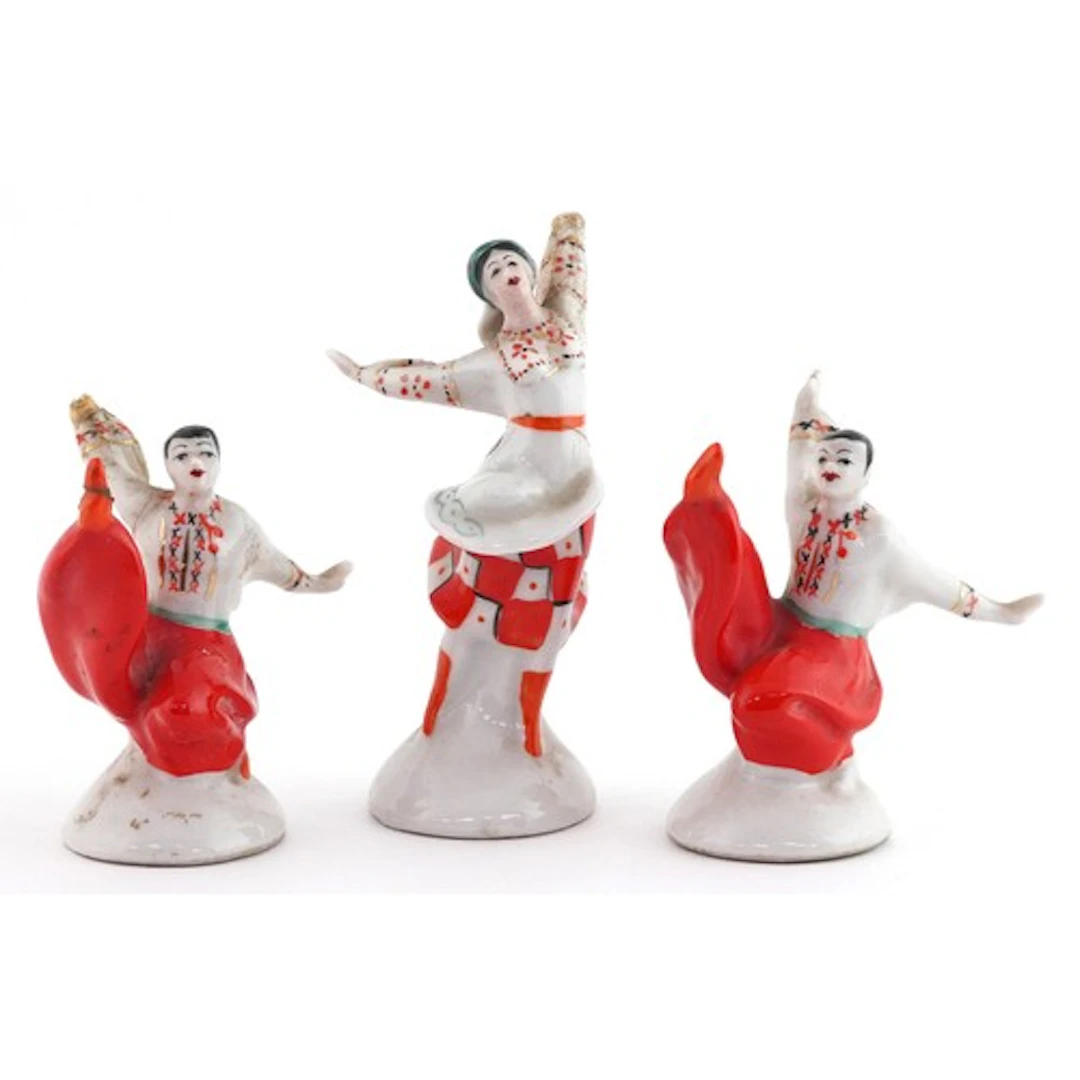Three Russian USSR porcelain dancers, each in traditional dr...