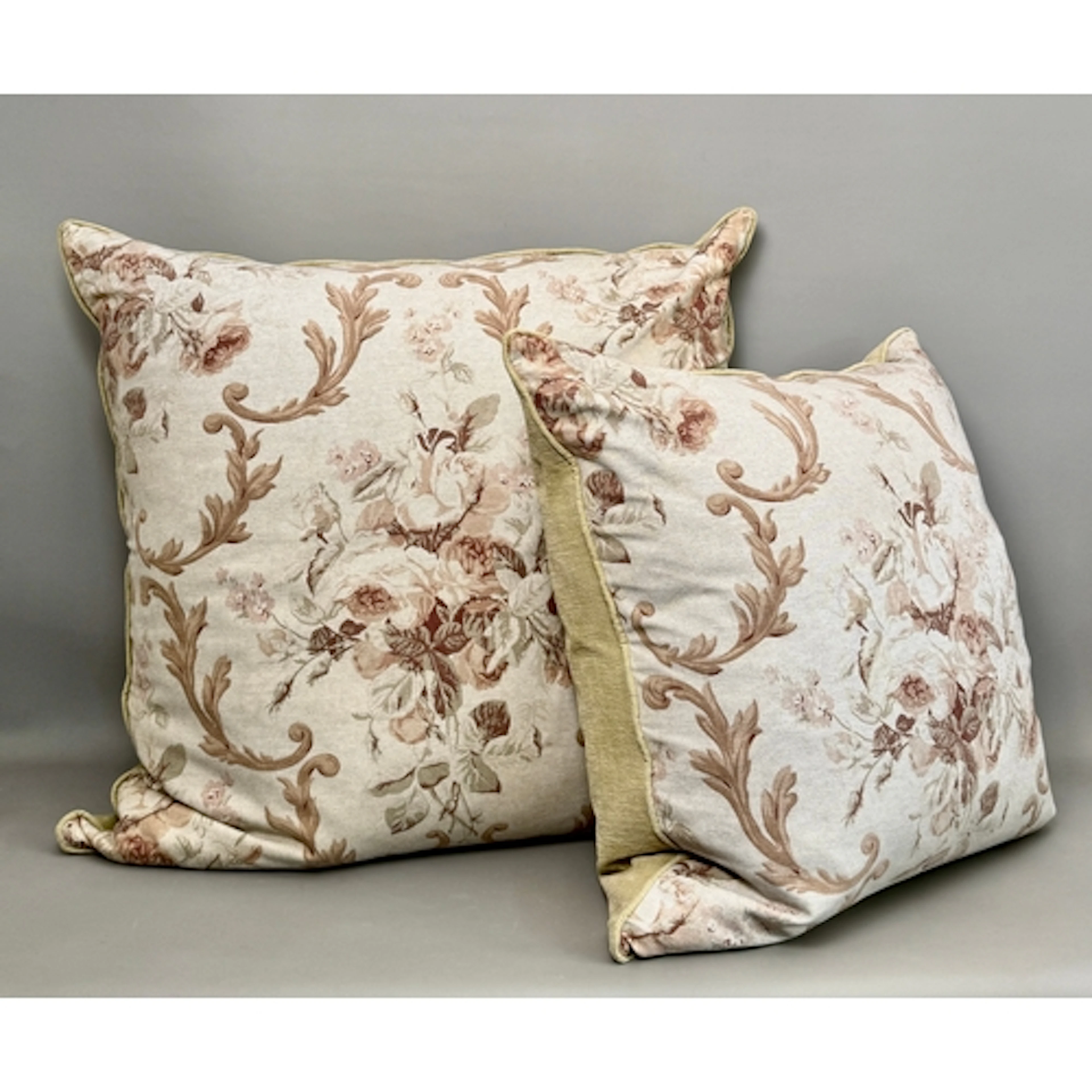 Two oversized matching cushions in a traditional design of f...