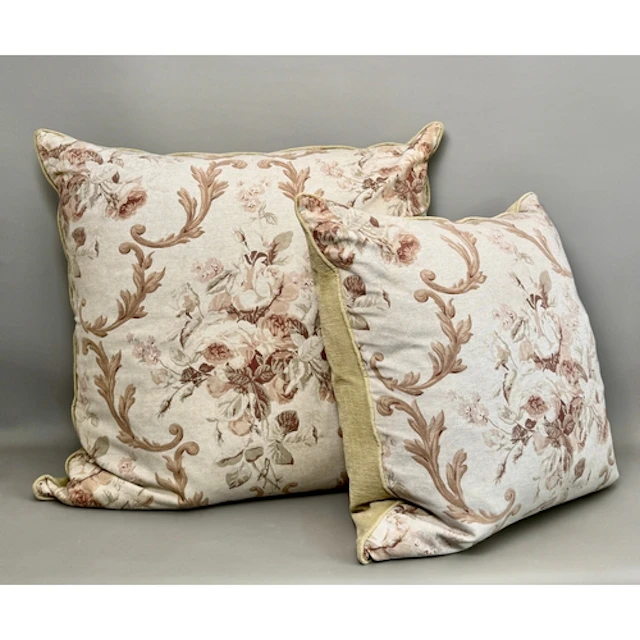 Two oversized matching cushions in a traditional design of f...