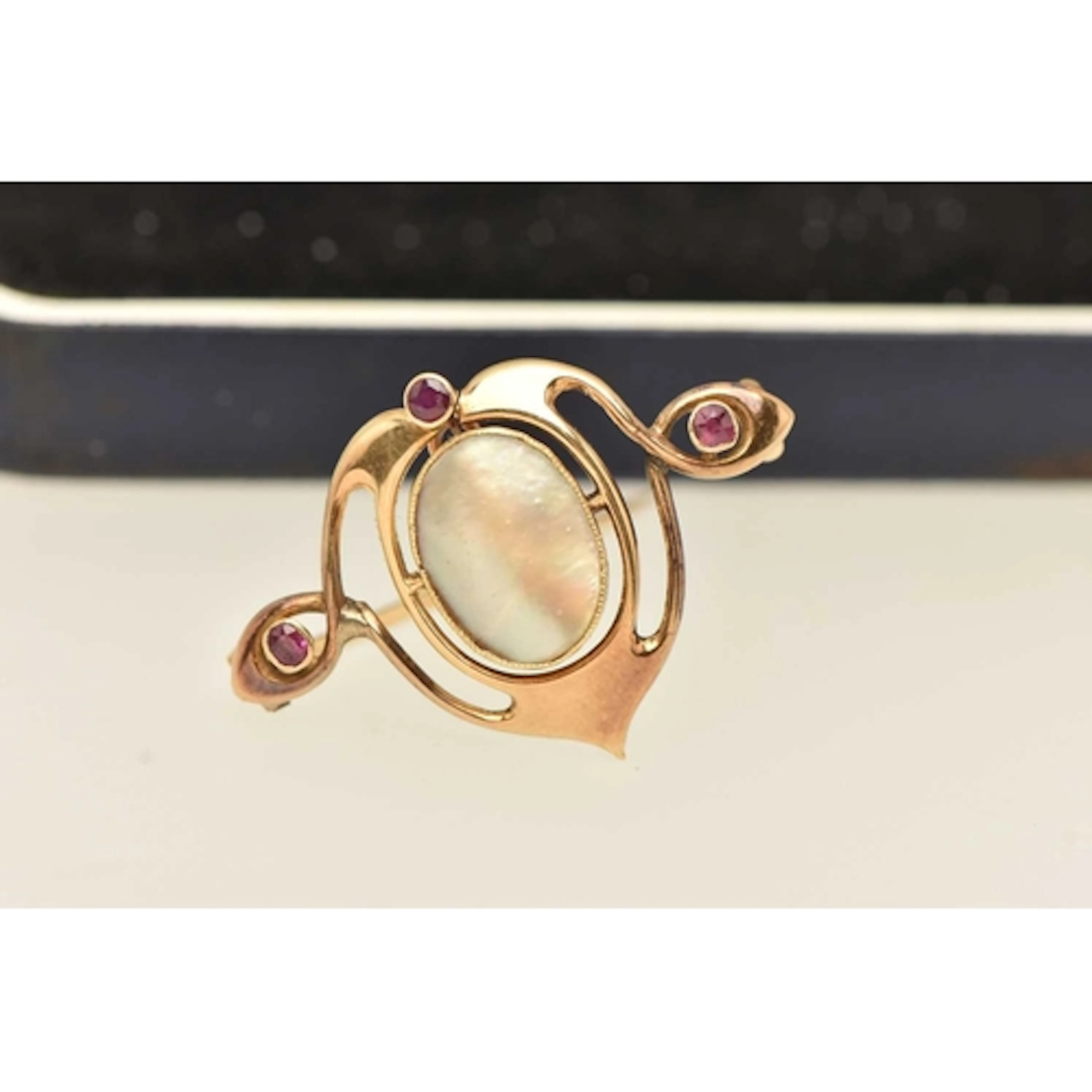AN ARTS AND CRAFTS 'MURRLE BENETT' BROOCH, an open work yell...