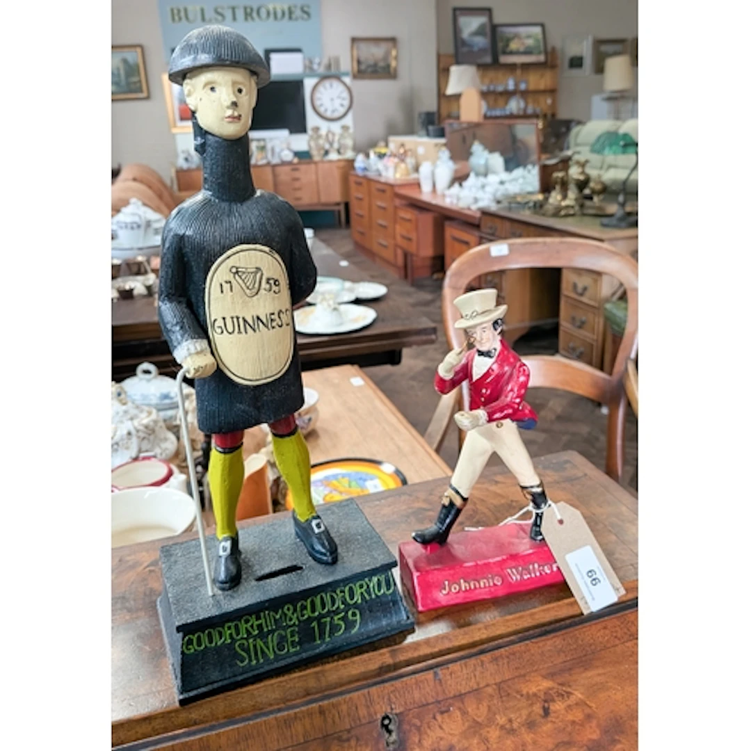 A painted metal Guinness figure advertising money box and a ...