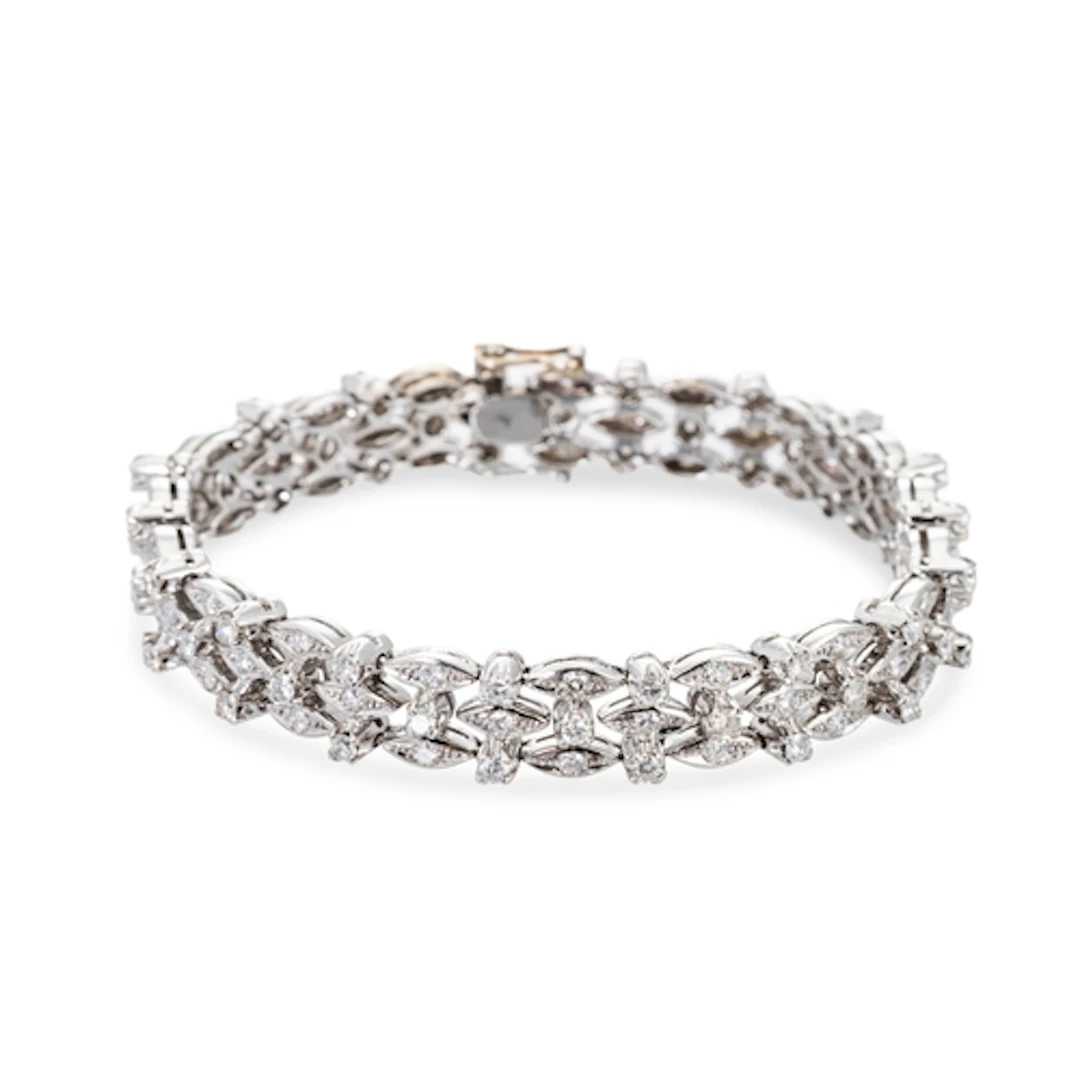 A DIAMOND OPENWORK CLUSTER BRACELET, mounted in 18ct white g...