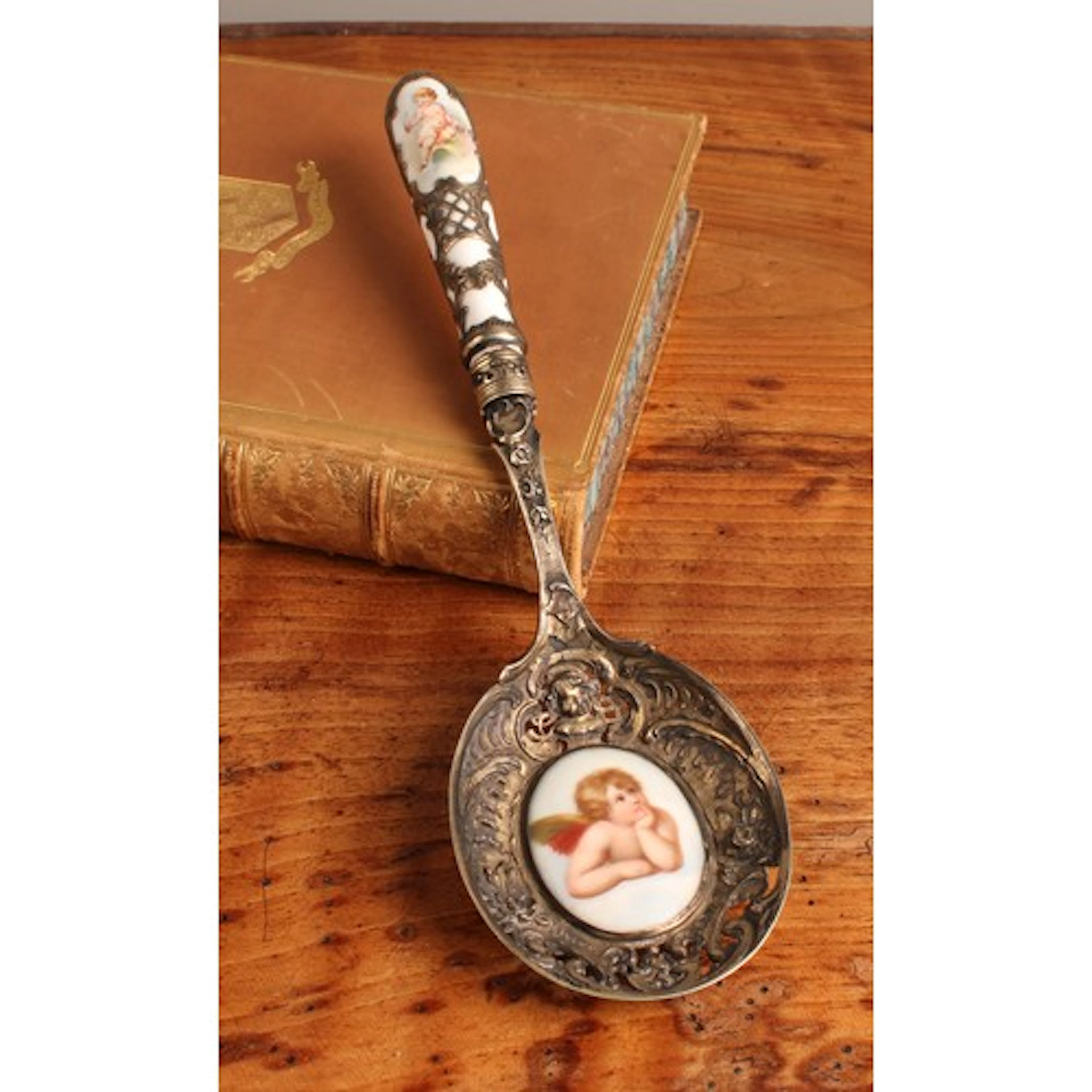 A German silver gilt and porcelain mounted spoon, pierced an...