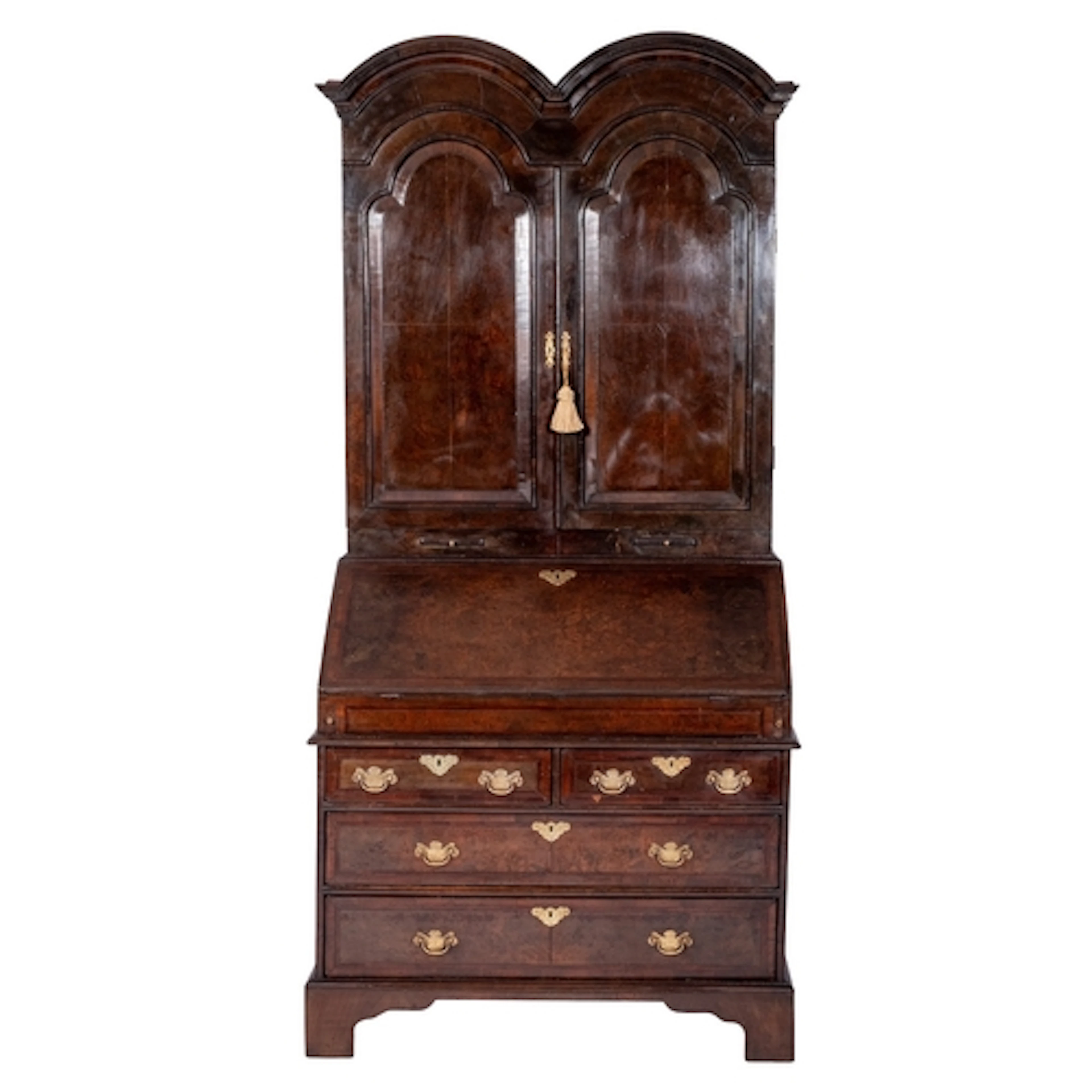 An early 18th century walnut double dome bureau cabinet, the...