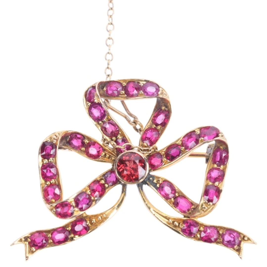 A Continental 14ct gold ruby ribbon bow brooch, set with rou...
