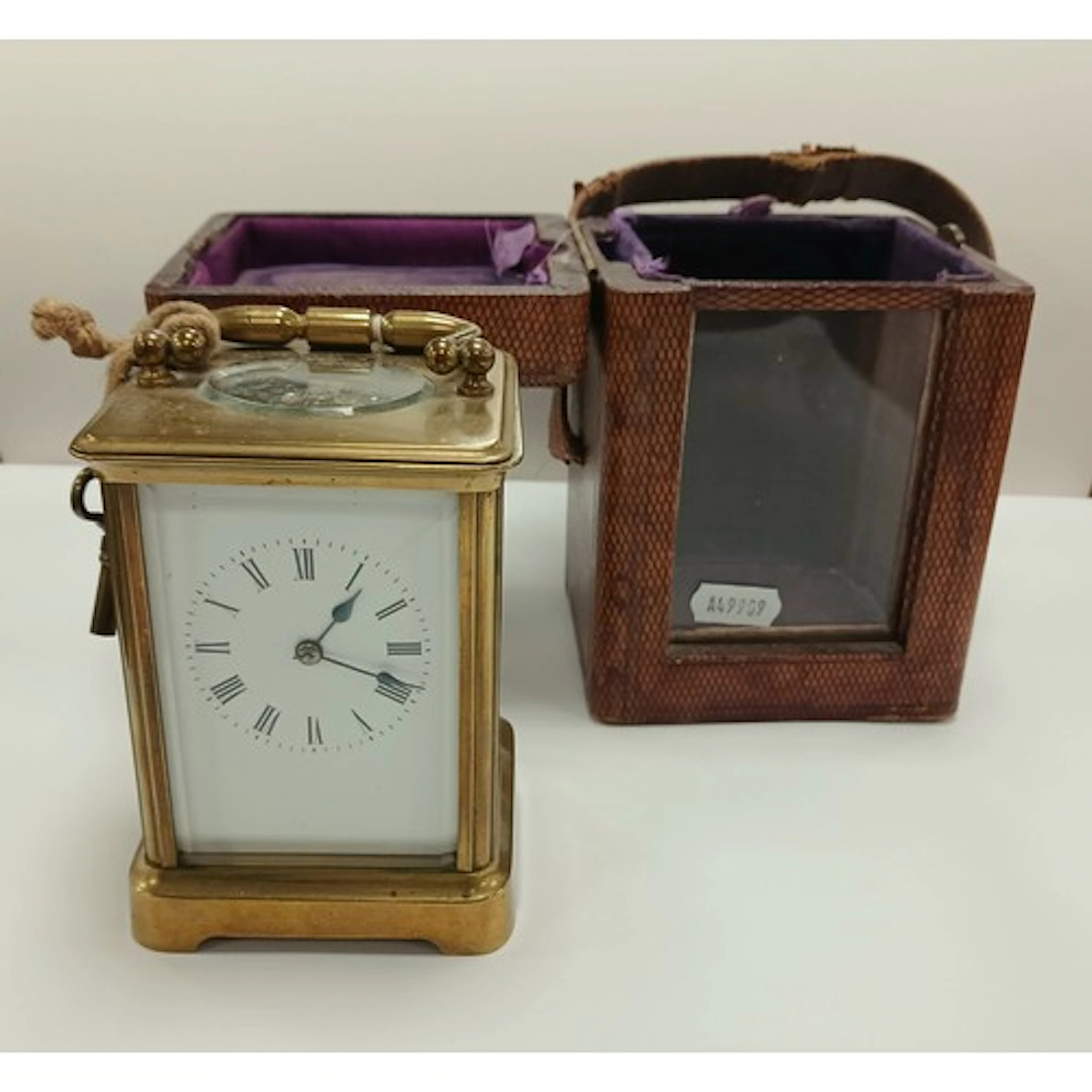 Brass carriage clock with white enamel dial, roman numerals,...