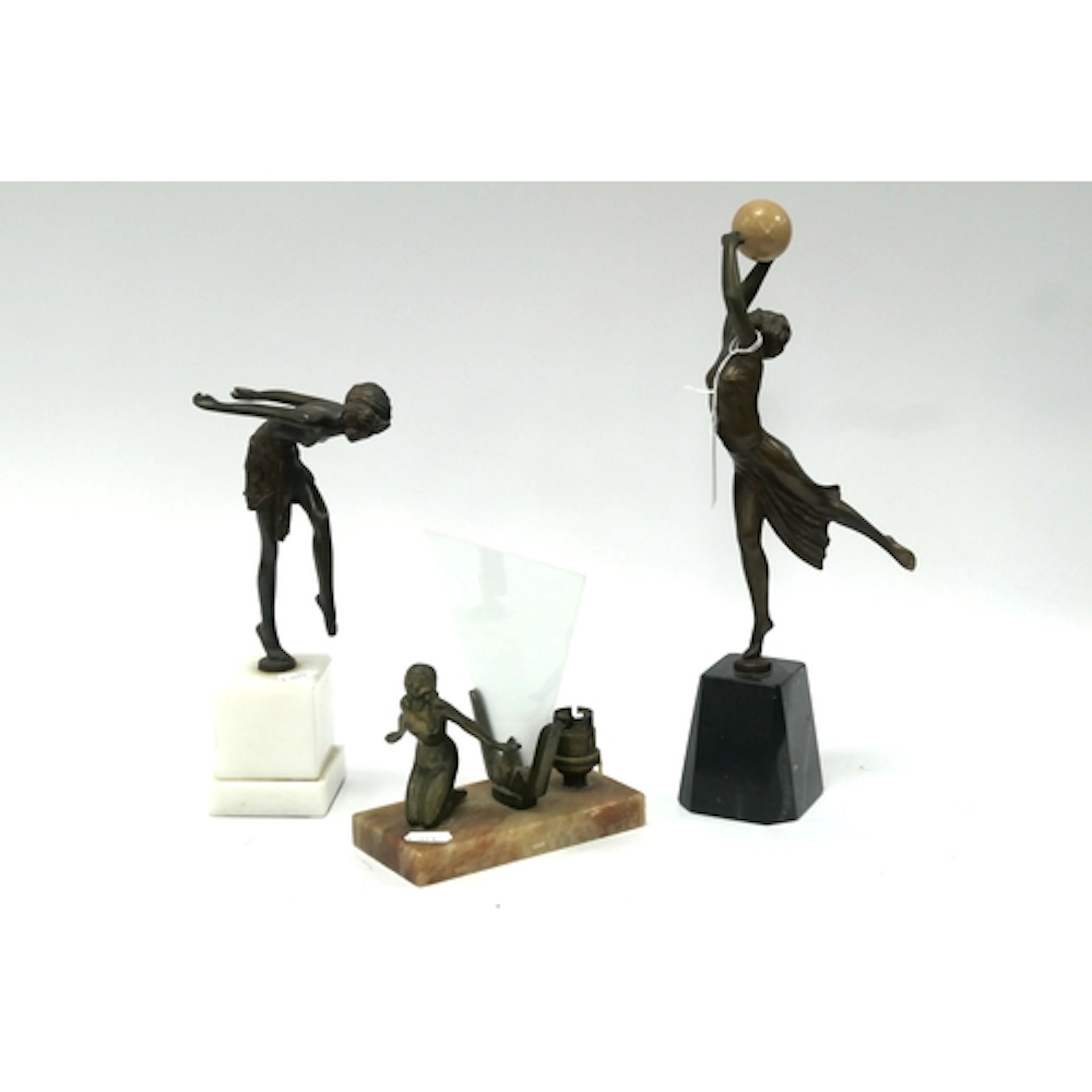 An Art Deco Speltre Table Lamp, the naked lady with her arms...