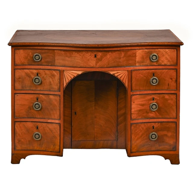 A George III serpentine mahogany kneehole dressing table, th...