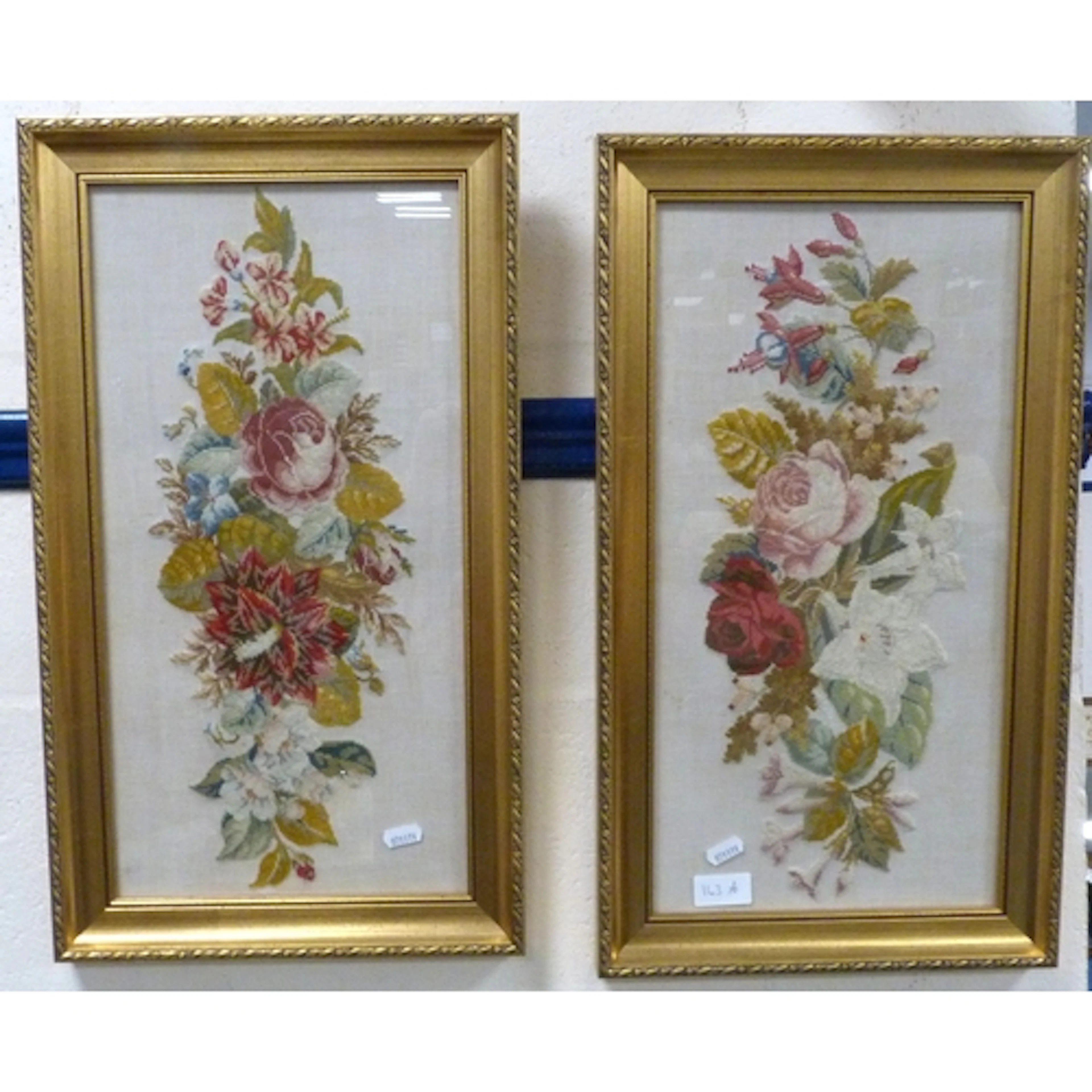 Pair of floral embroideries, framed and glazed.
