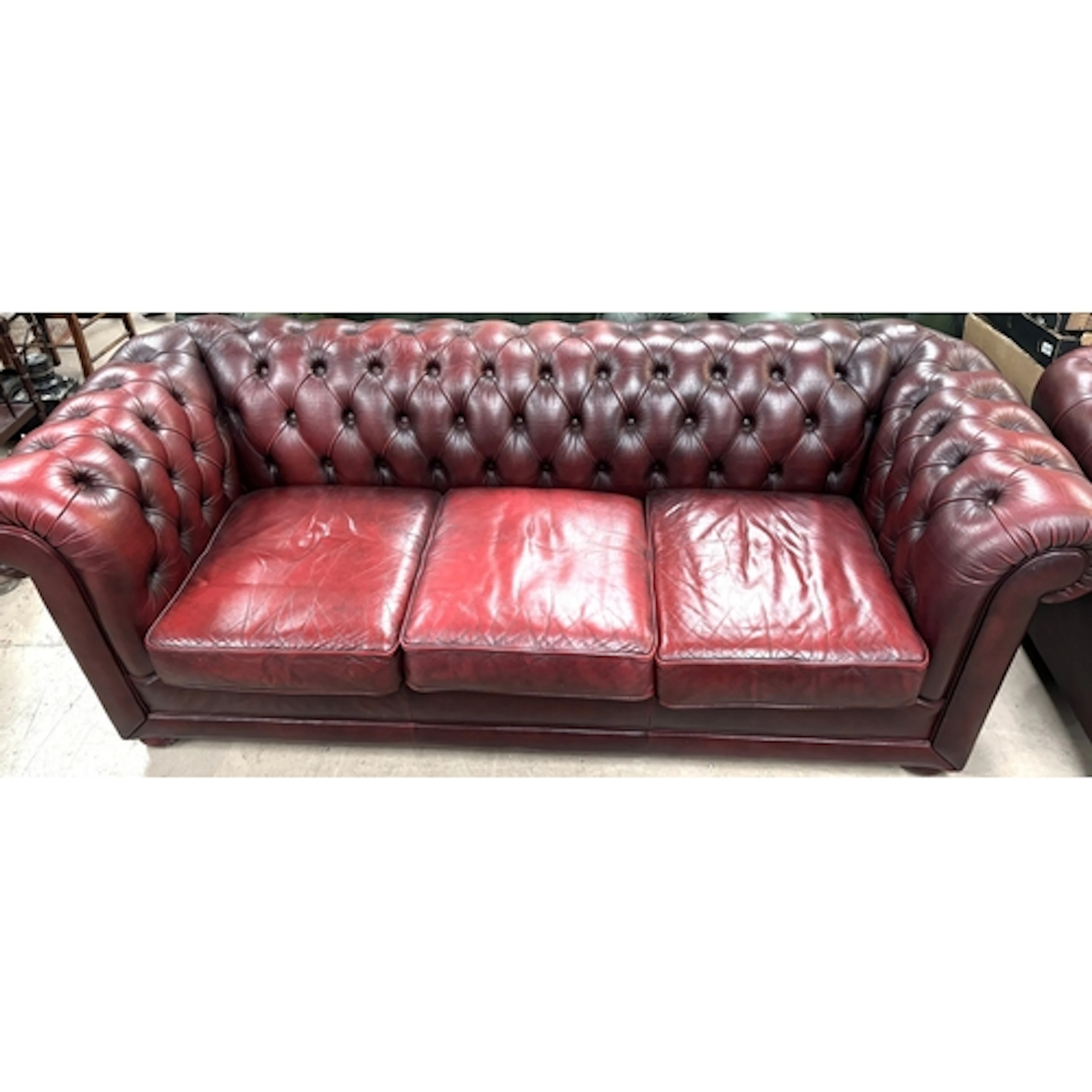 A deeply buttoned 3 seater Chesterfield settee in "antique" ...