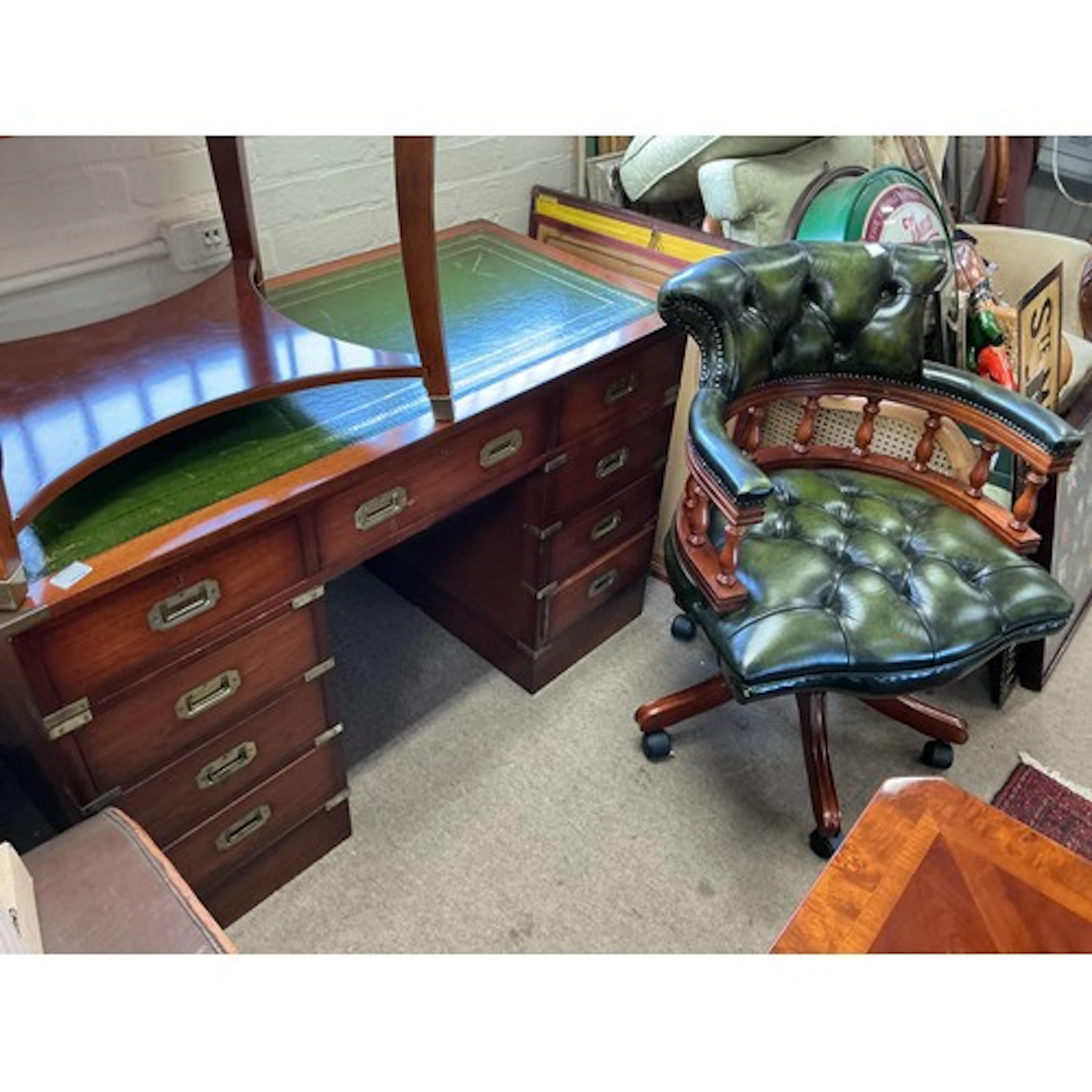 A pedestal desk fitted with flush mounted brass handles and ...