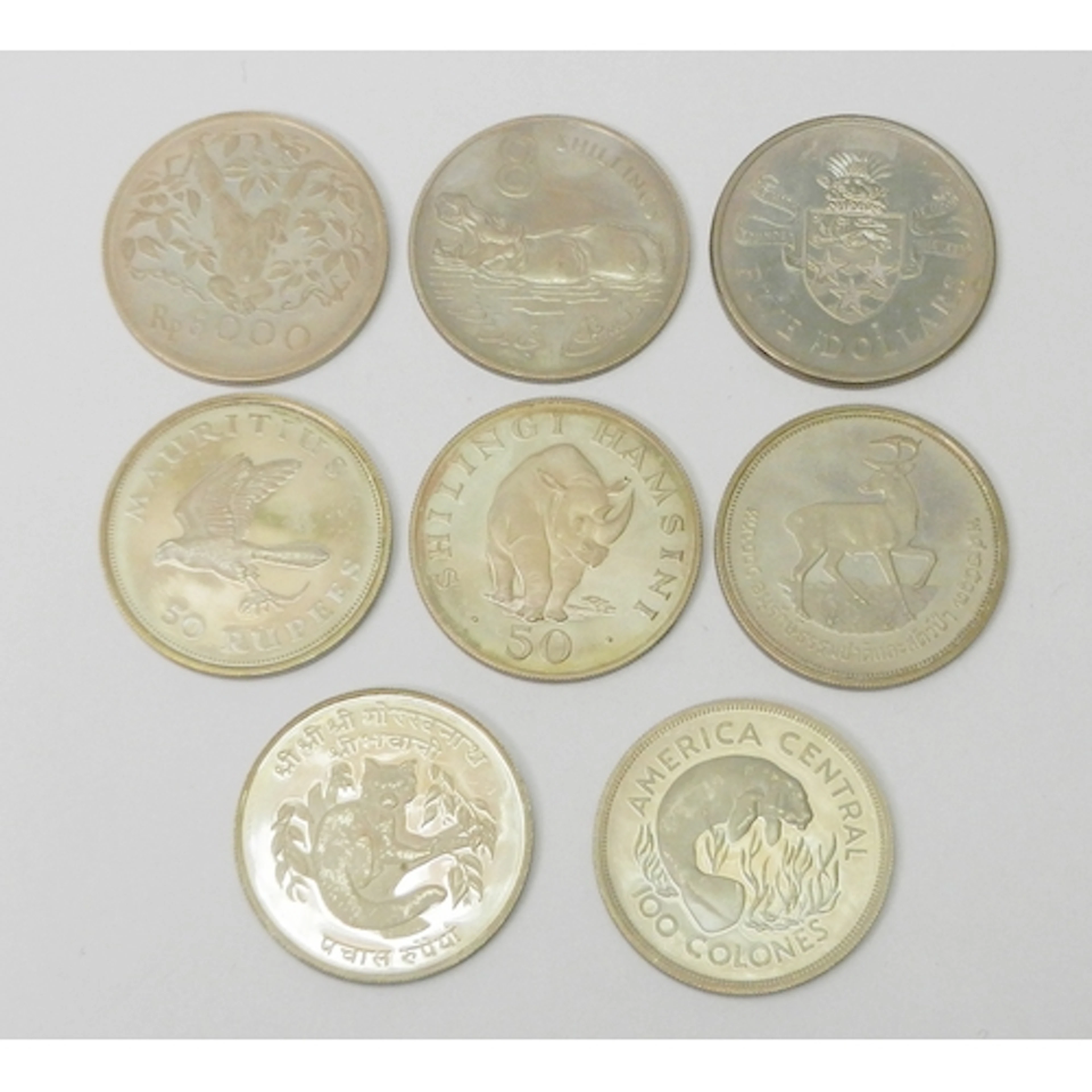 Eight various commemorative coins, including Cayman Islands ...