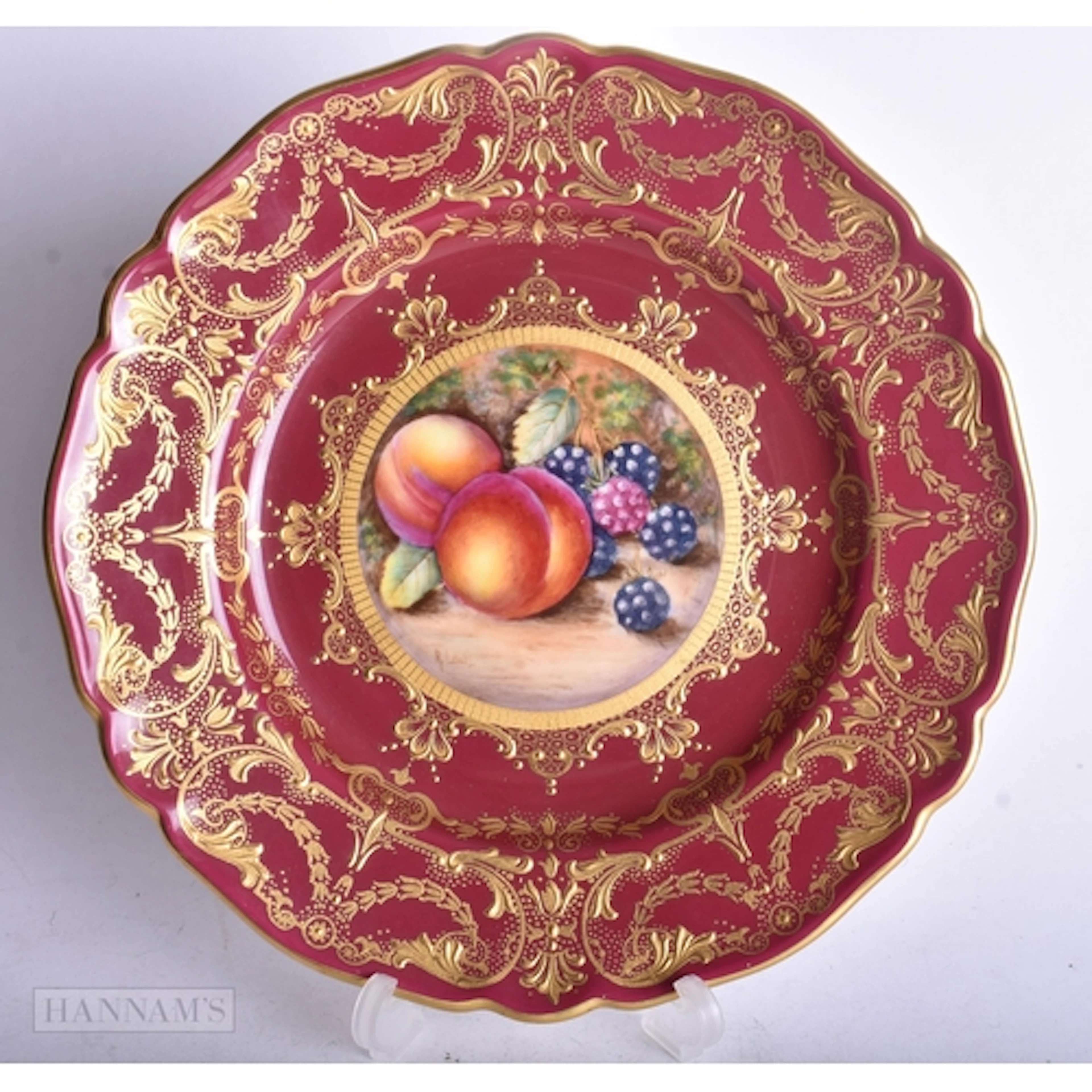 Royal Worcester claret ground plate painted with fruit on a ...
