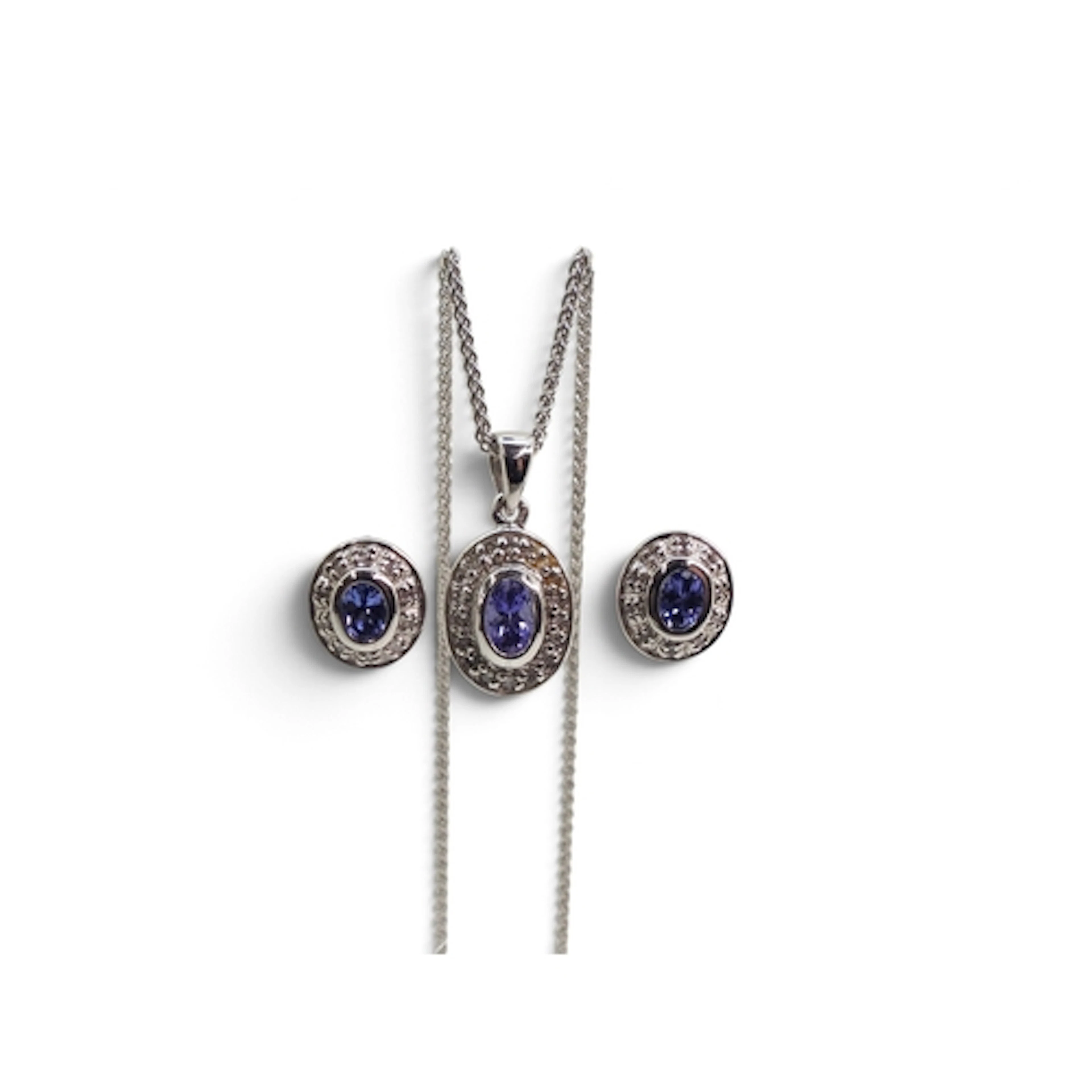 A 9ct white gold tanzanite and diamond pendant on a 56cm 9ct...